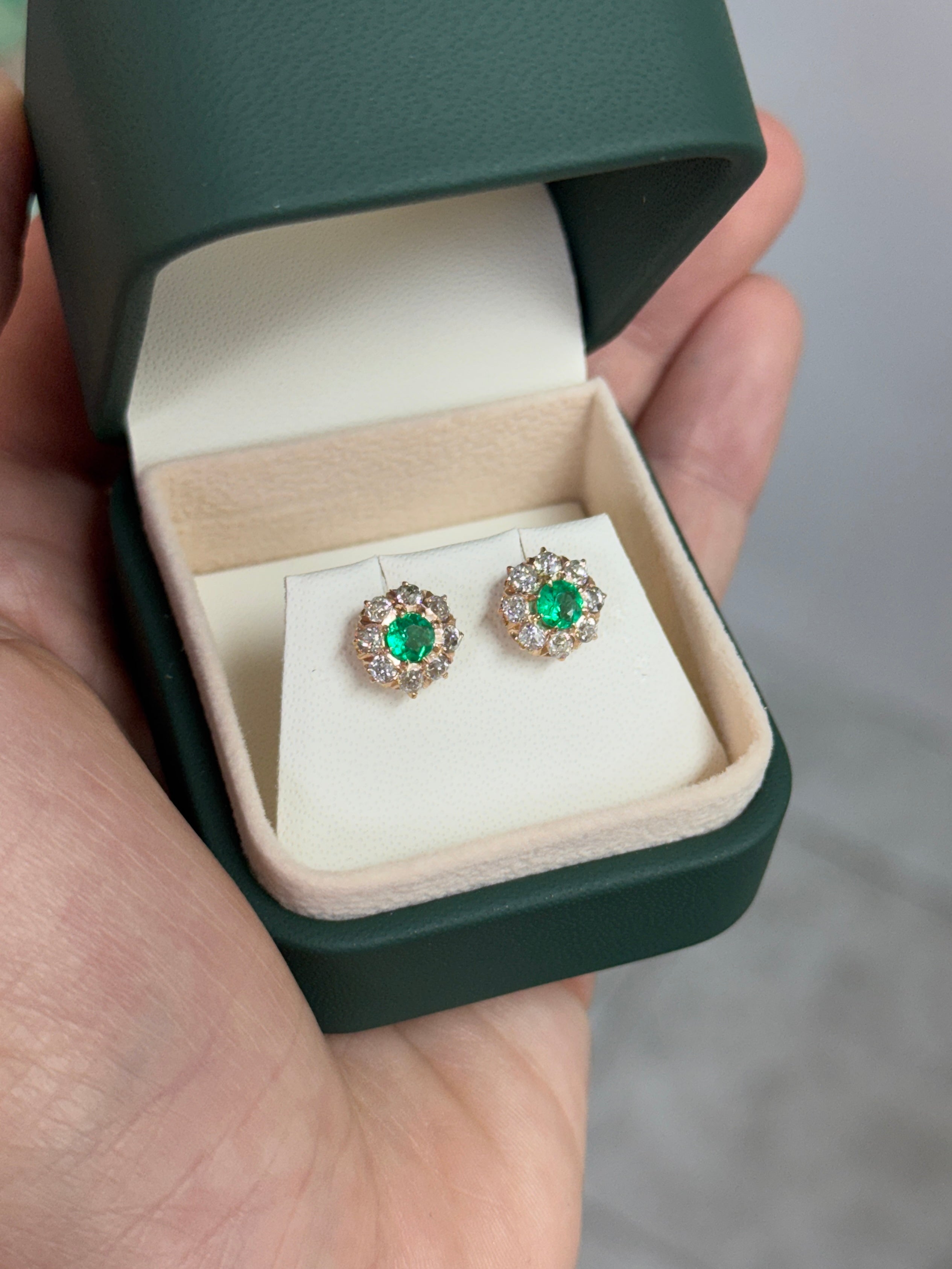 Vivid Colombian emerald halo stud earrings with old European cut diamonds in 14K gold, featuring 2.10tcw total weight.