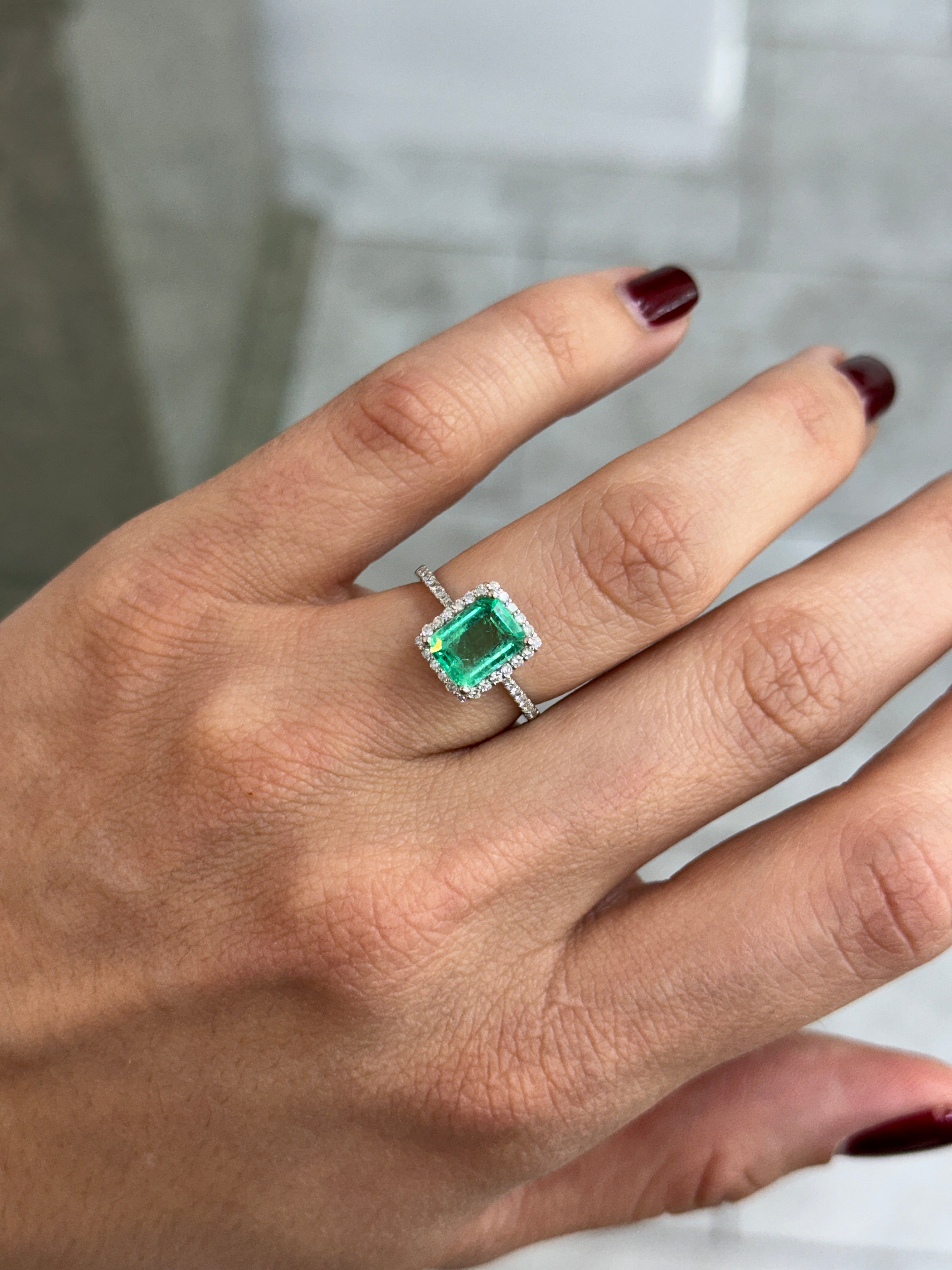 JR Colombian Emeralds 14K white gold engagement ring with 1.70tcw crystal clear Colombian emerald and diamond halo design.