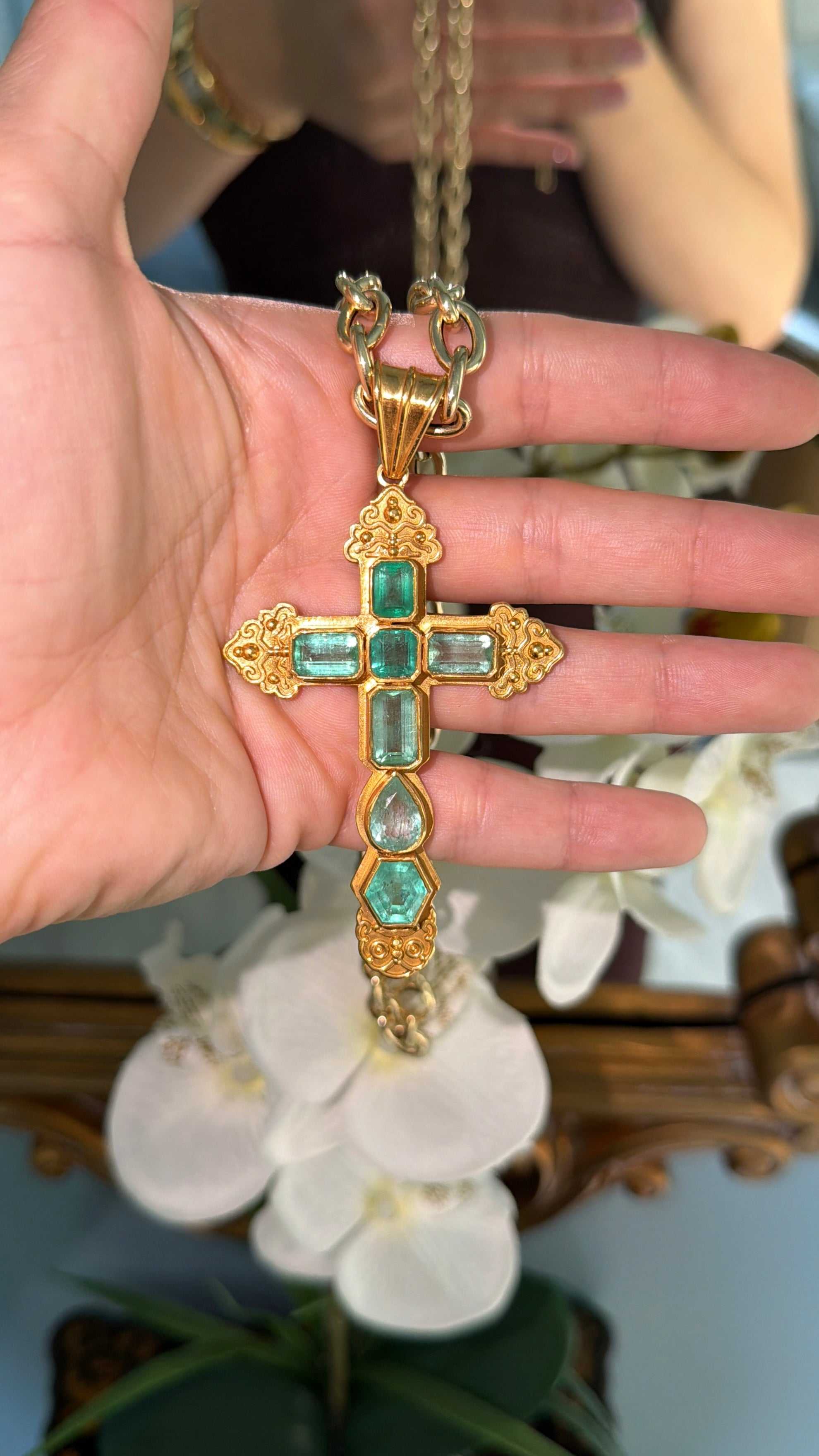 Natural Colombian emerald cross pendant with sterling silver and gold plating, featuring 24.55TCW of vibrant emeralds.