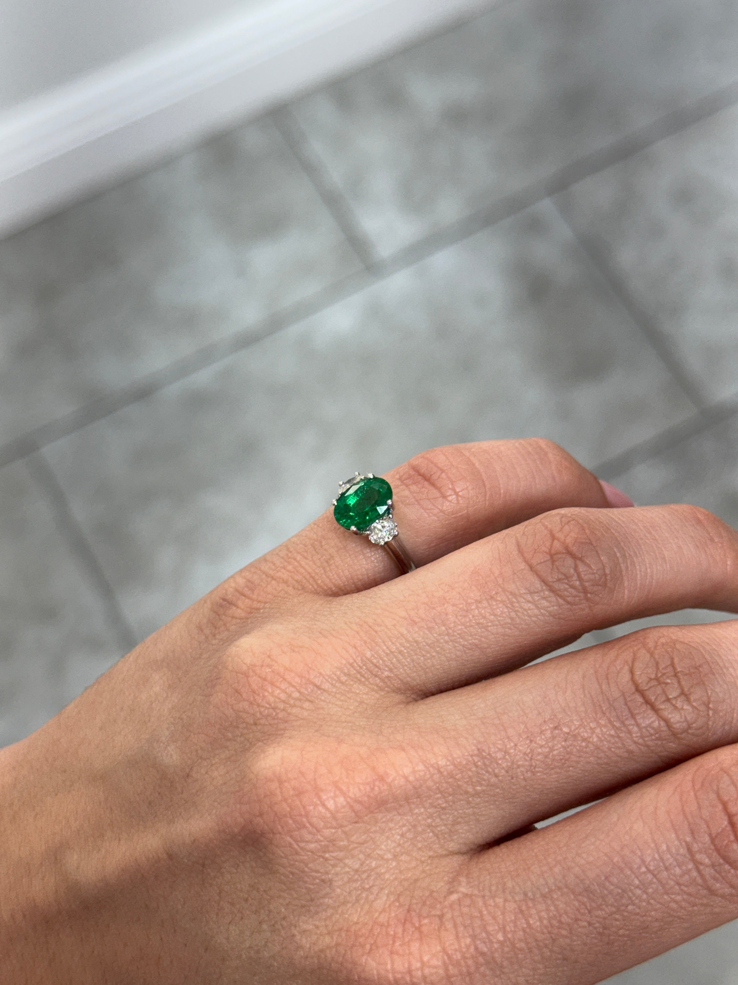 Vivid green oval emerald and diamond three-stone ring in platinum, featuring 2.97tcw from JR Colombian Emeralds.