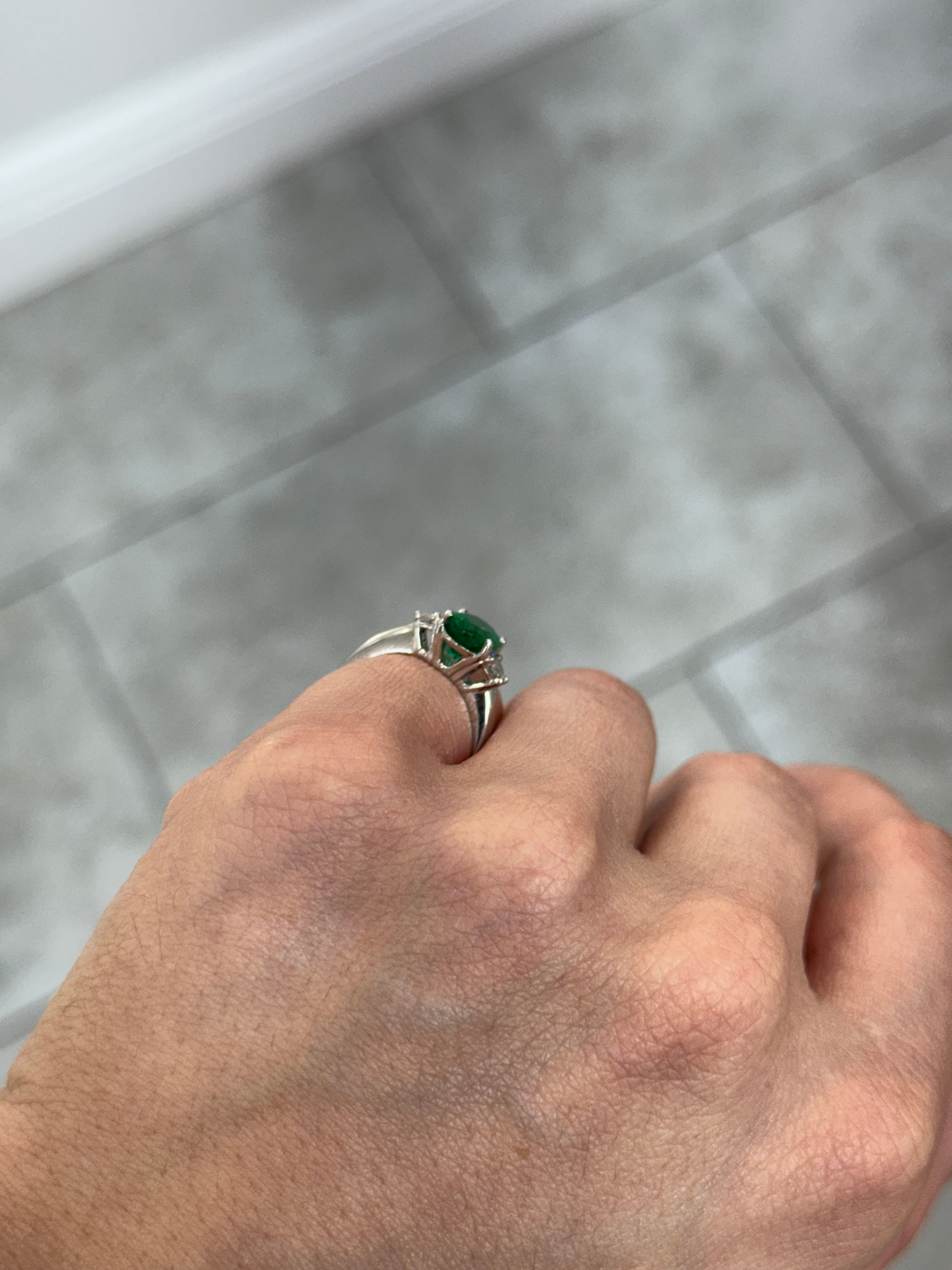 Vivid green oval emerald and oval diamond three-stone ring in platinum, jewelry by JR Colombian Emeralds.