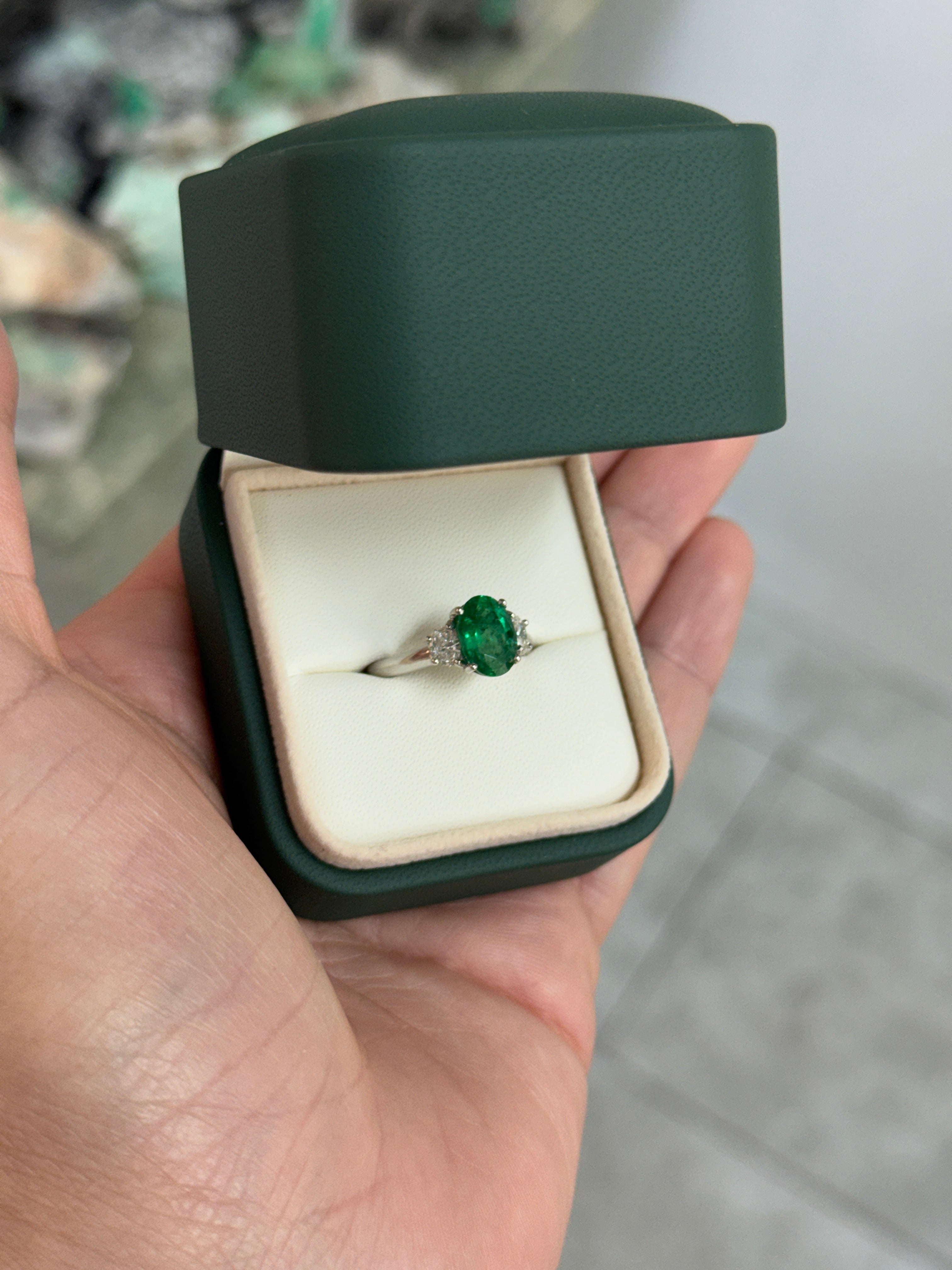 Vivid green oval emerald and diamond three-stone ring in platinum, featuring 2.97 carats total weight, by JR Colombian Emeralds.
