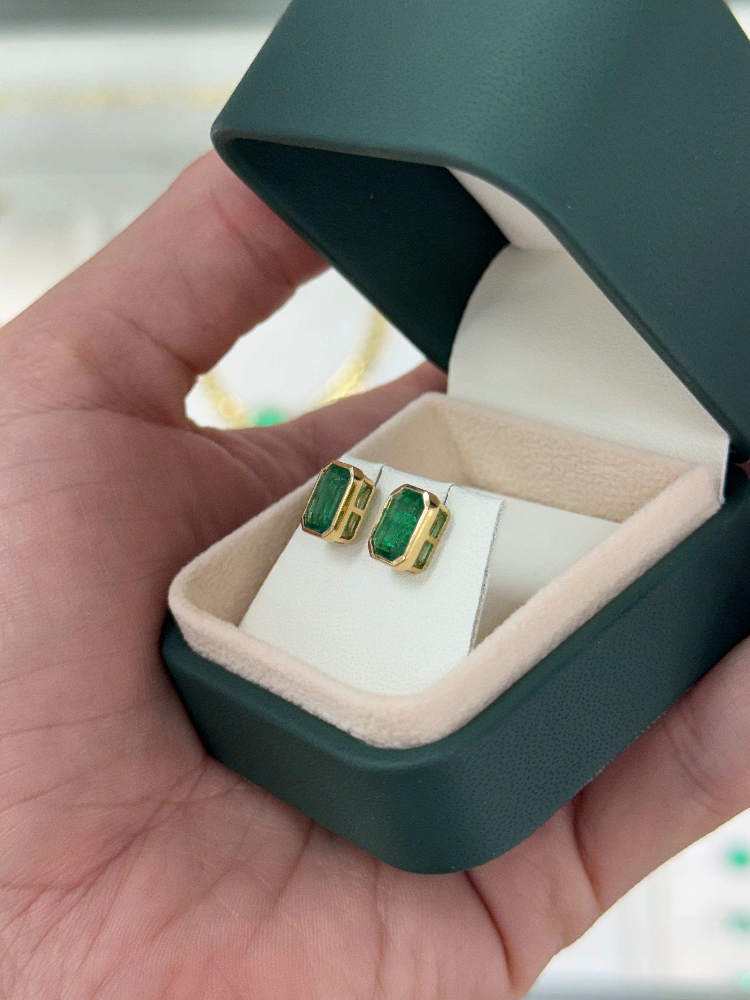 Angelina Jolie bezel set emerald stud earrings with 3.33tcw from JR Colombian Emeralds, featuring vibrant green emeralds in 18K gold.