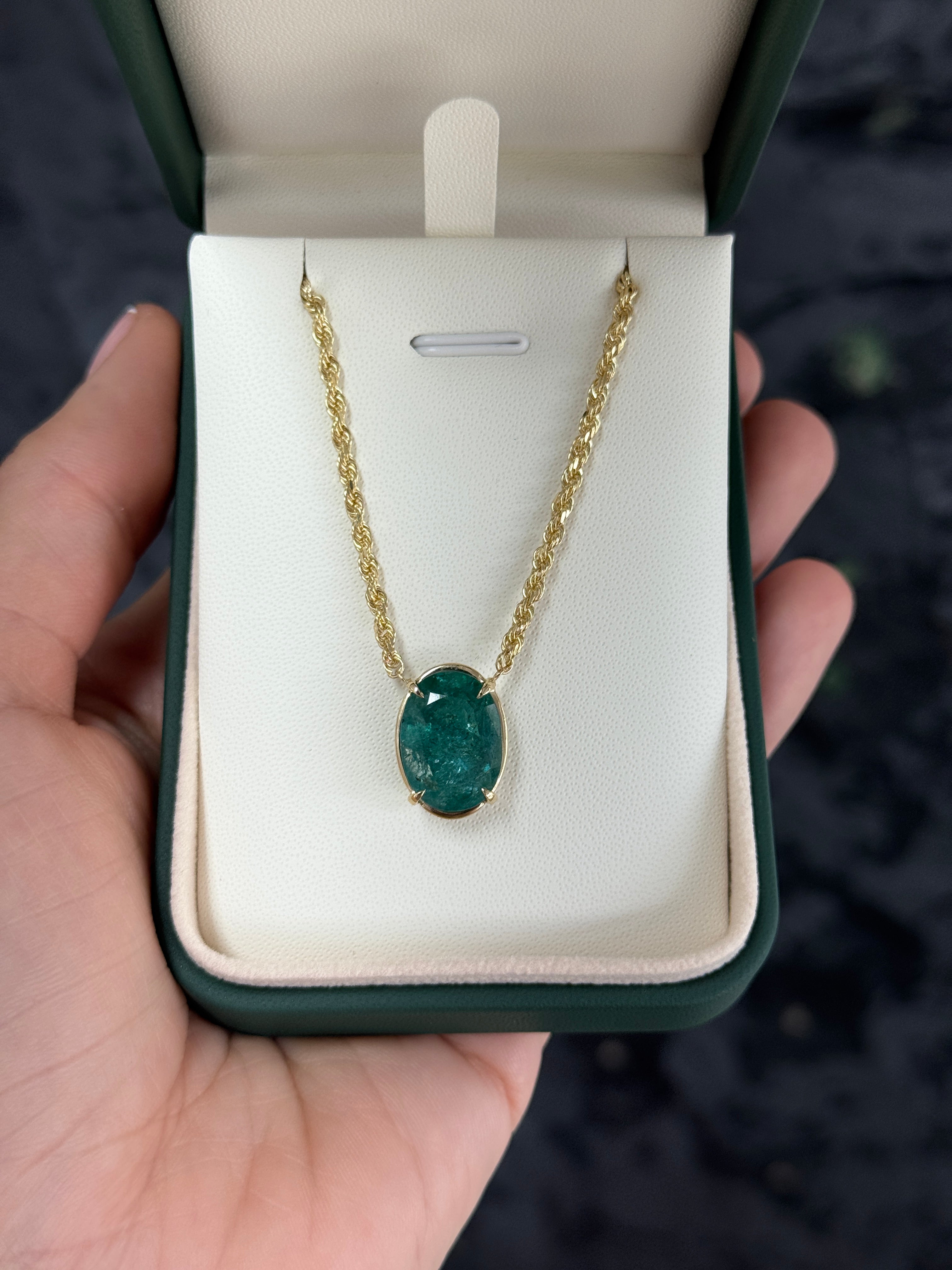 Oval emerald solitaire pendant necklace in 14K yellow gold, featuring a 9-carat gemstone from JR Colombian Emeralds.