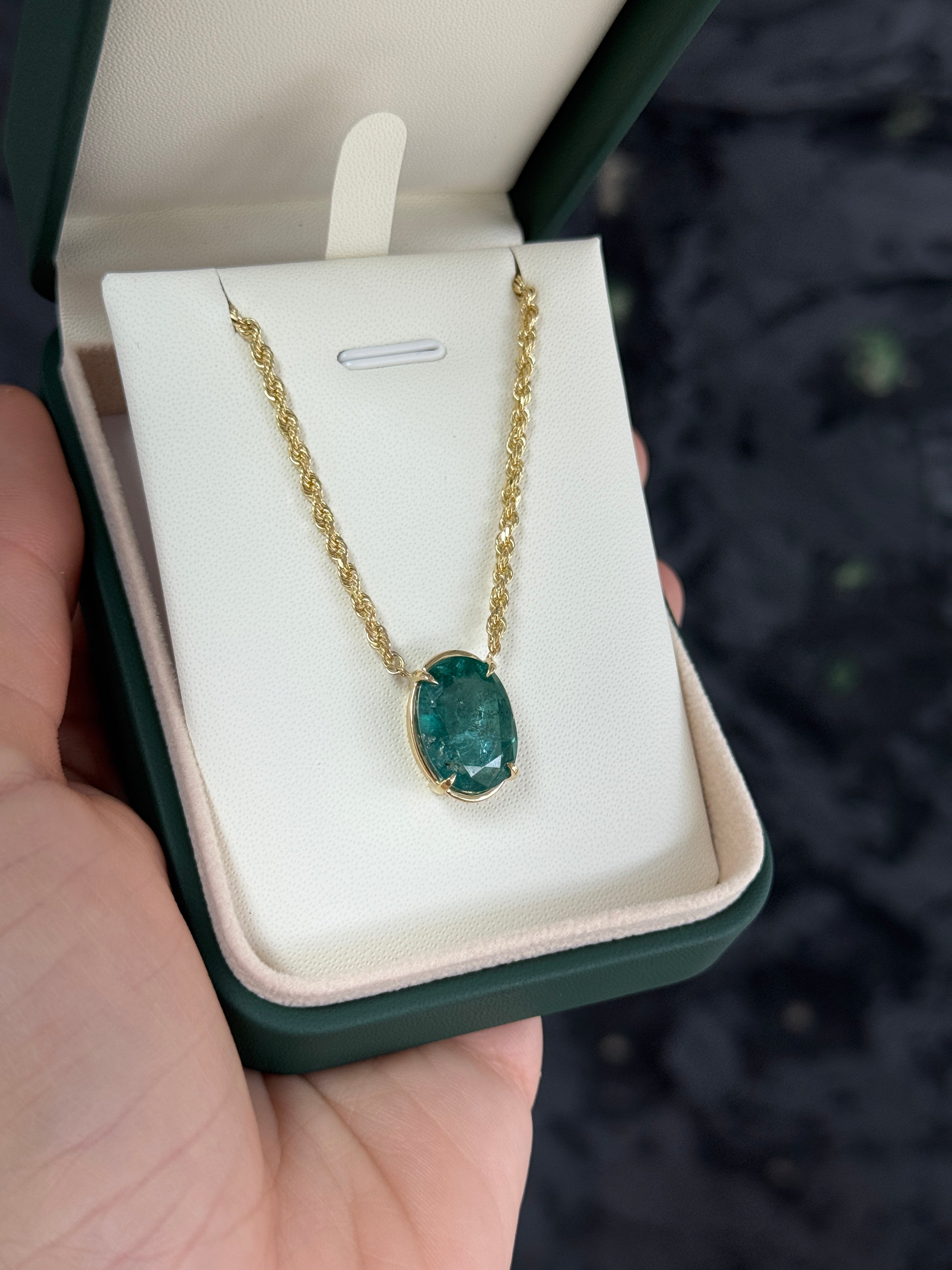 9 Carat oval emerald solitaire necklace in 14K yellow gold featuring a single emerald gemstone on a delicate chain.