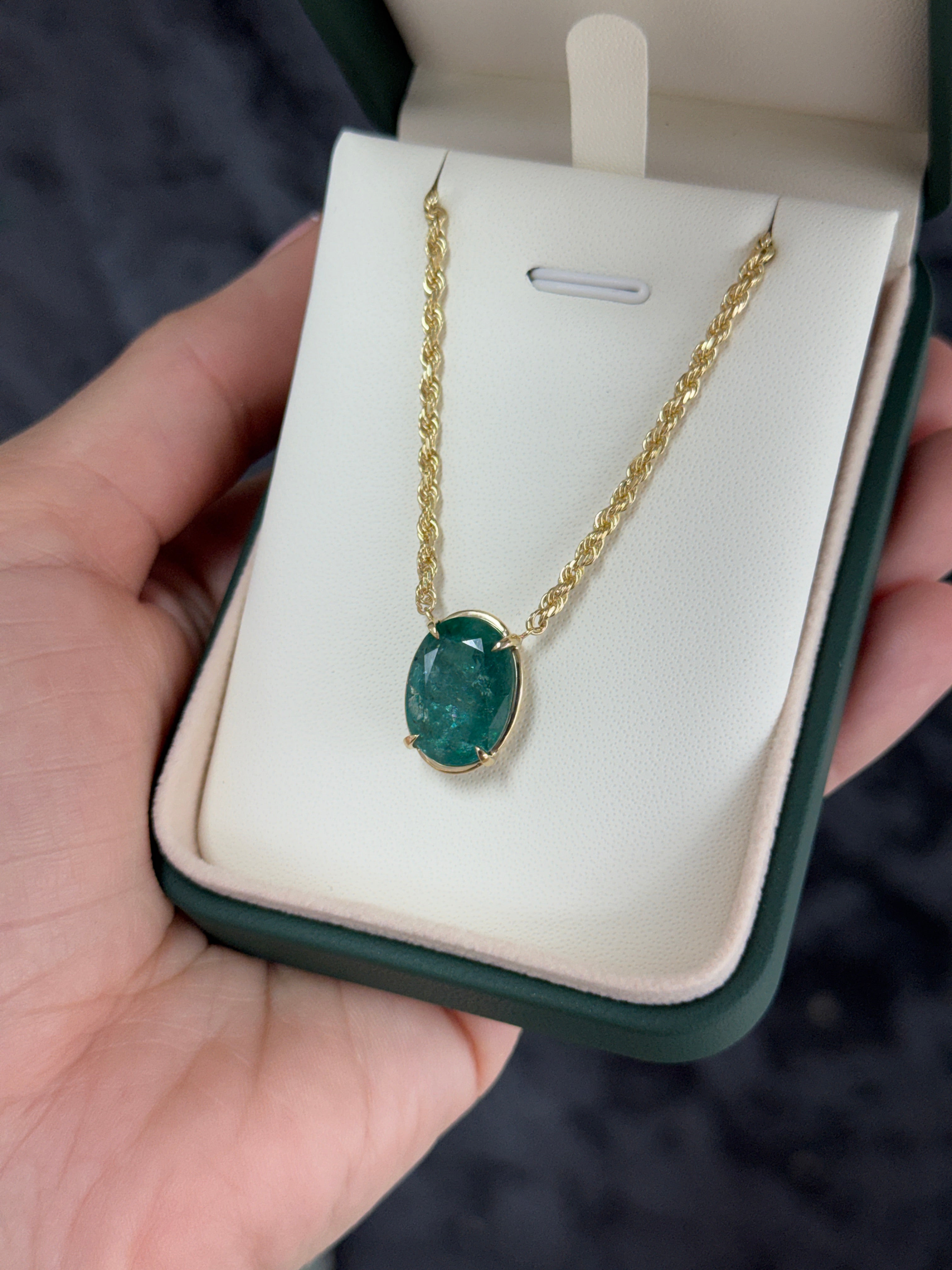 9 Carat Oval Emerald Yellow Gold Solitaire Necklace featuring a solid 14K yellow gold chain and a central oval emerald gemstone.