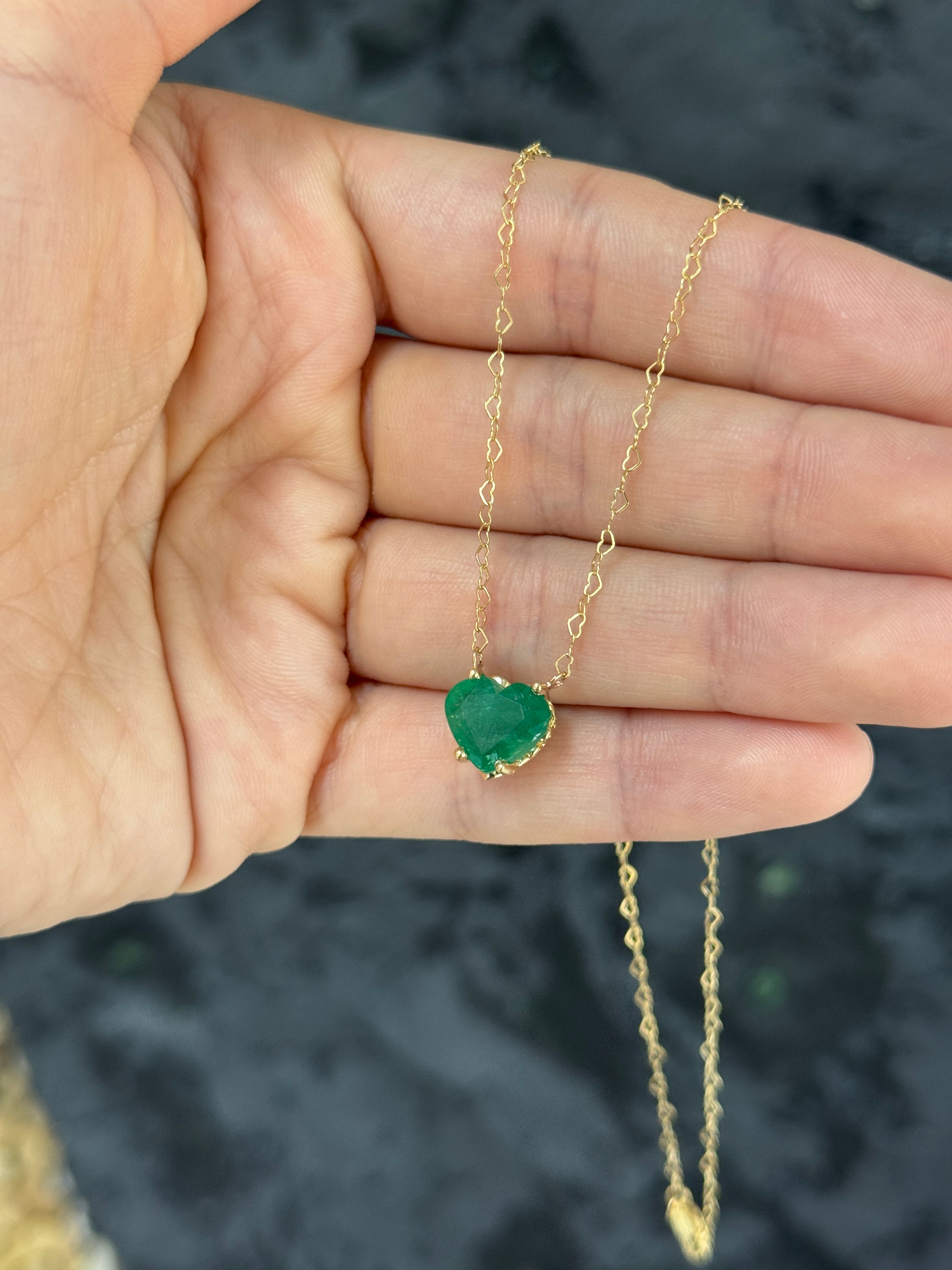 Natural Zambian emerald heart-shaped solitaire necklace by JR Colombian Emeralds, featuring a 4.07 carat vibrant green gemstone.