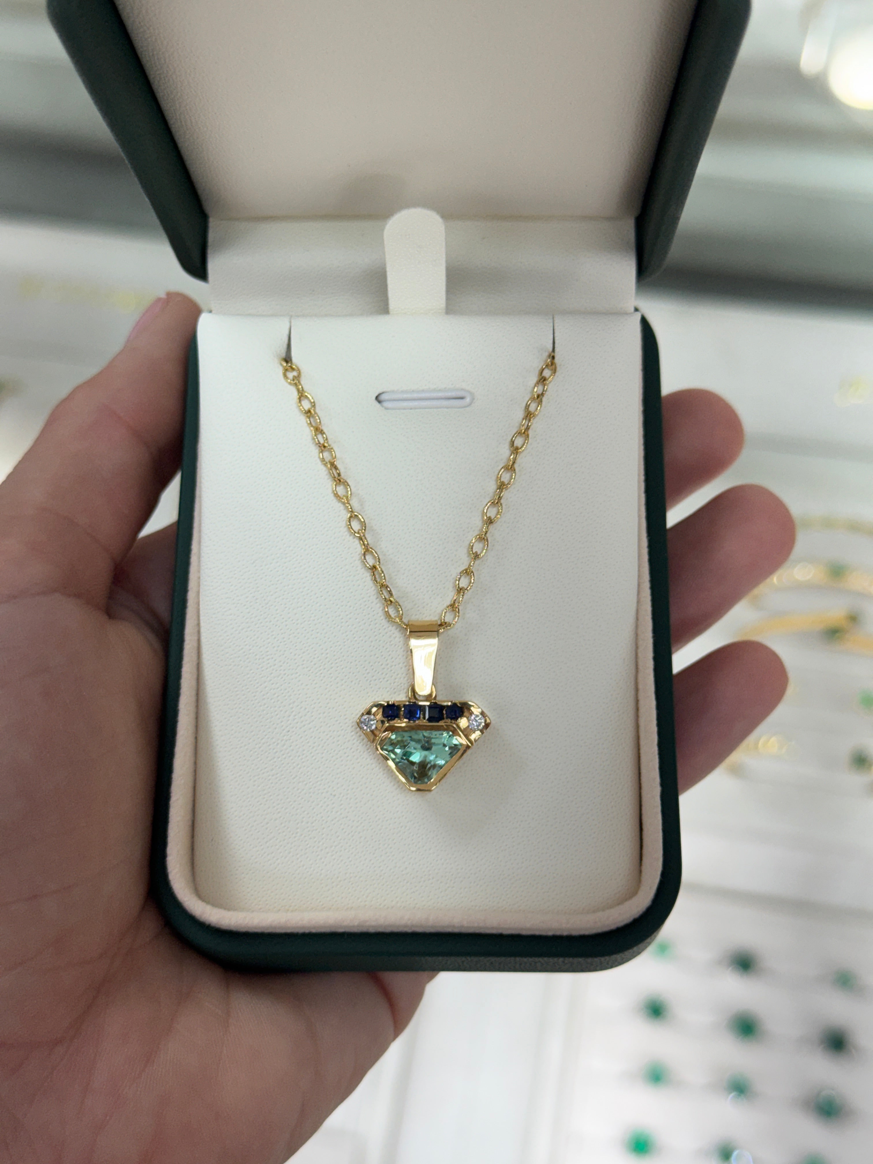 VVS clarity Colombian emerald shield cut pendant with blue sapphire and diamonds, featuring 2.80 carats, by JR Colombian Emeralds