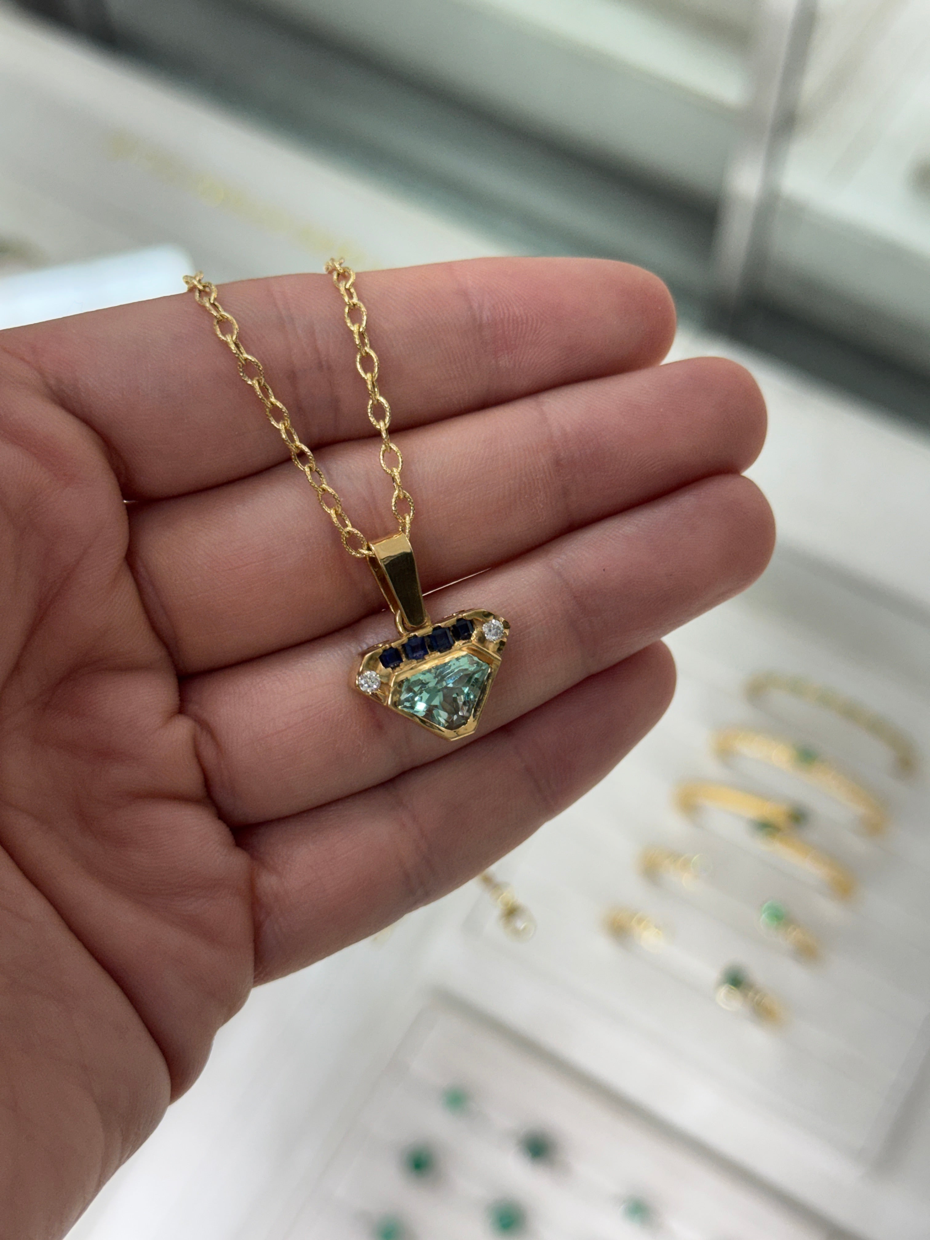 VVS Colombian emerald shield cut pendant with blue sapphire and diamonds, featuring 2.80 carats total weight, by JR Colombian Emeralds