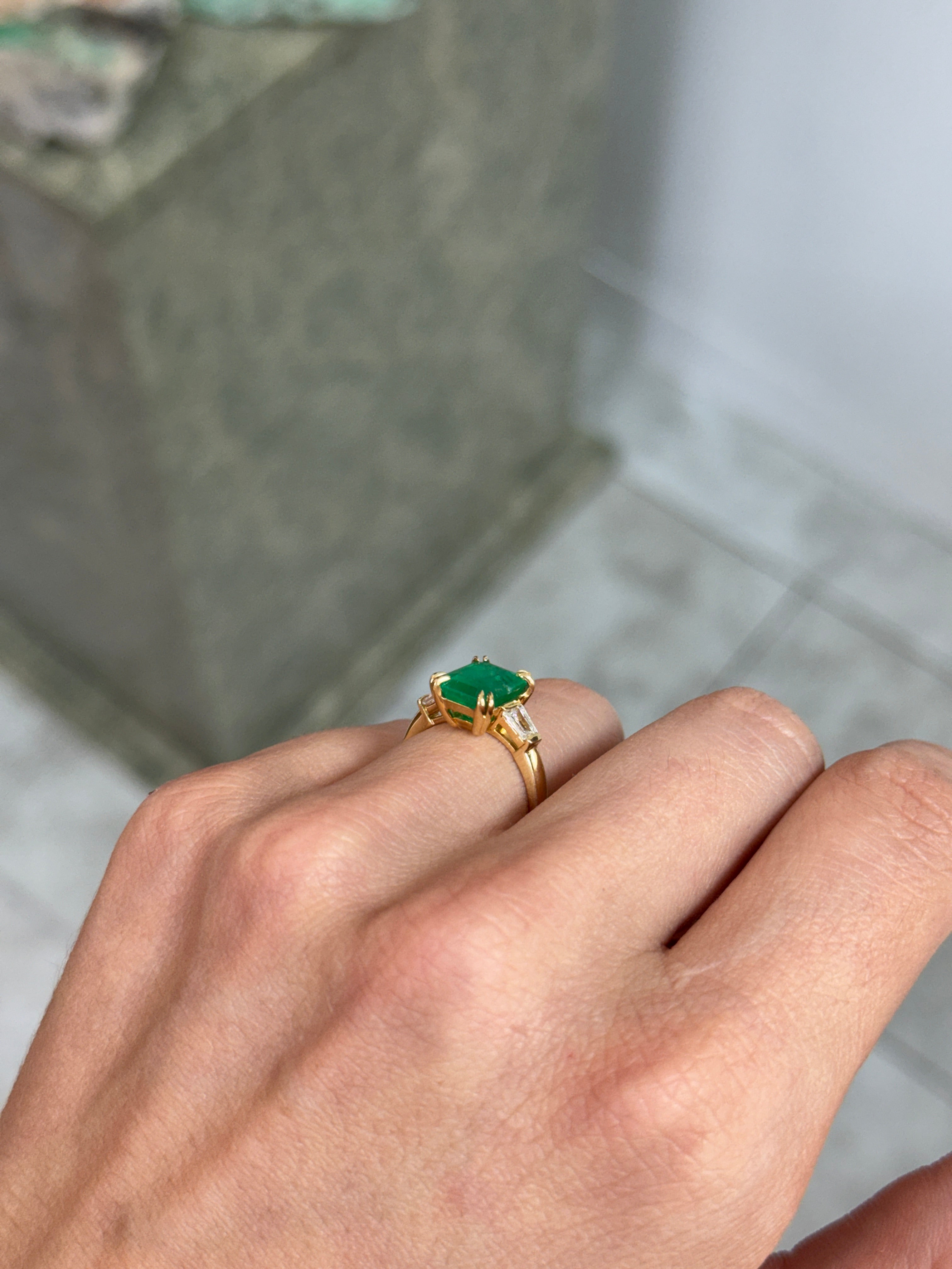 18K Colombian Emerald and tapered baguette diamond ring with 3.36tcw, featuring vibrant green emeralds and sparkling diamonds.