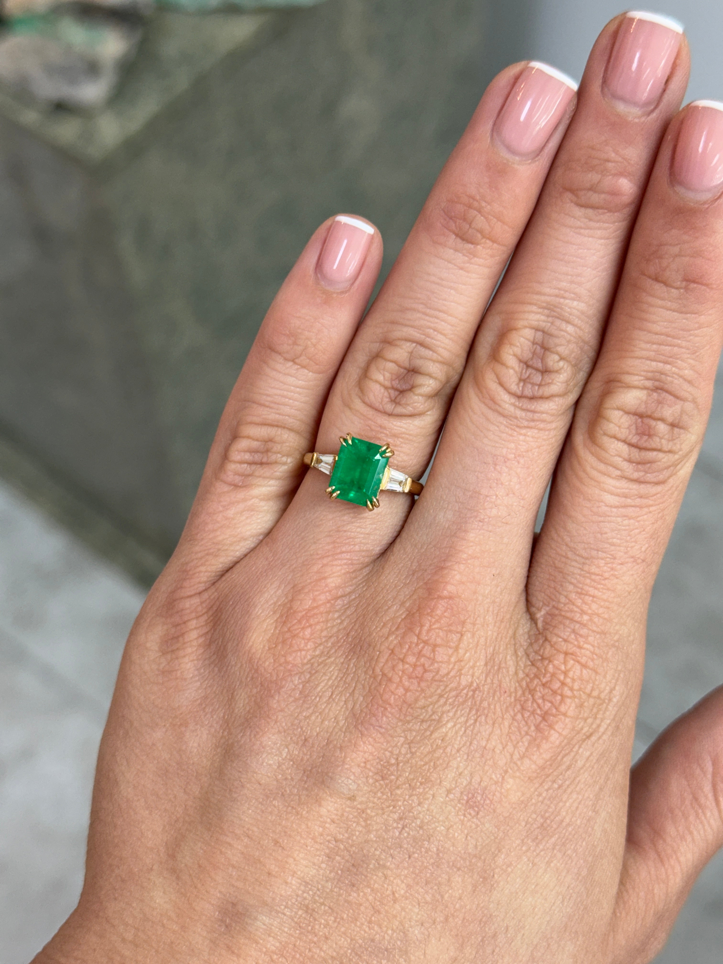 18K Colombian Emerald and tapered baguette diamond ring with 3.36tcw, featuring vibrant green emeralds and sparkling diamonds.