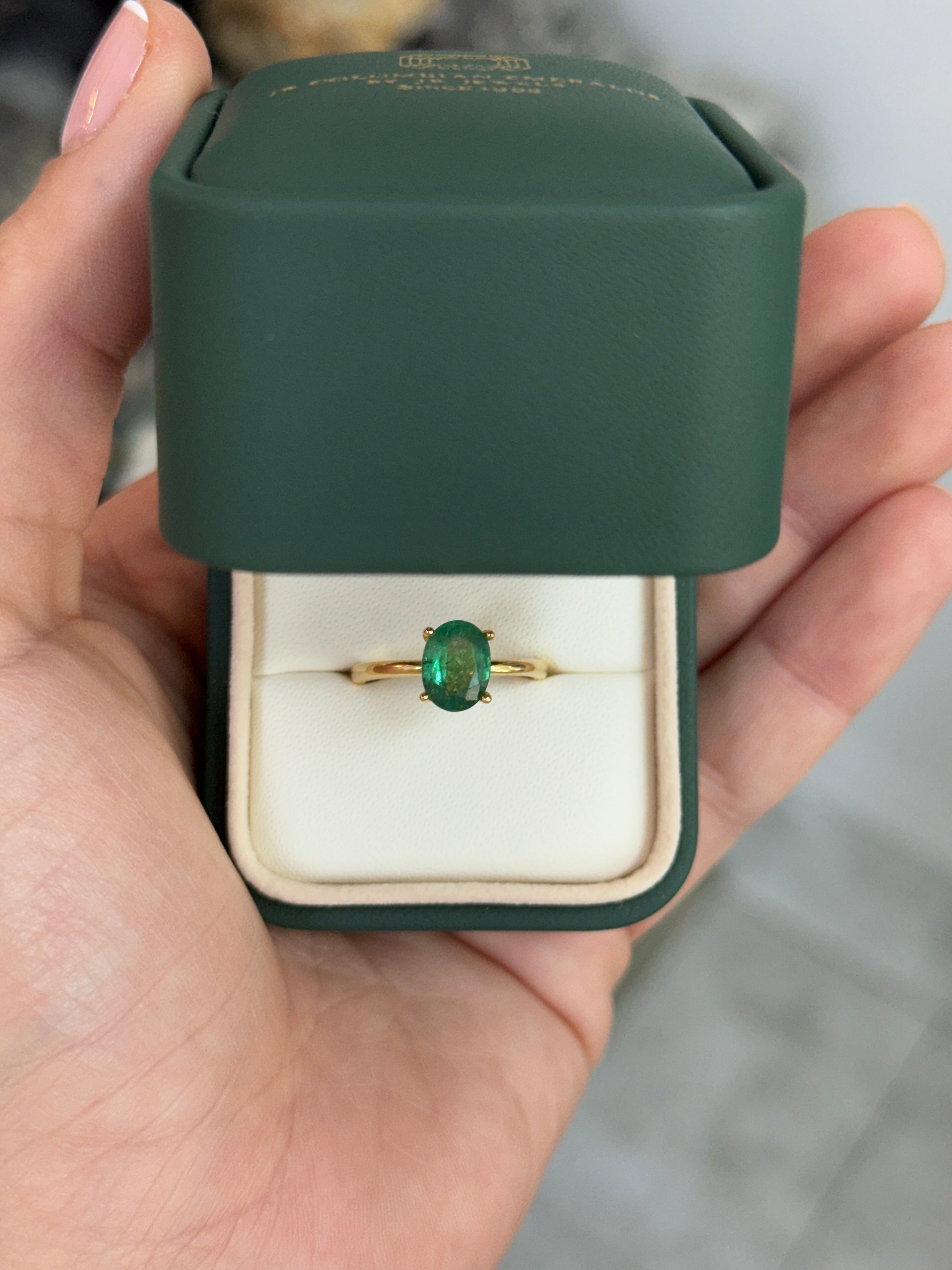 Natural emerald oval cut solitaire engagement ring with 18K gold setting and four prongs by JR Colombian Emeralds.
