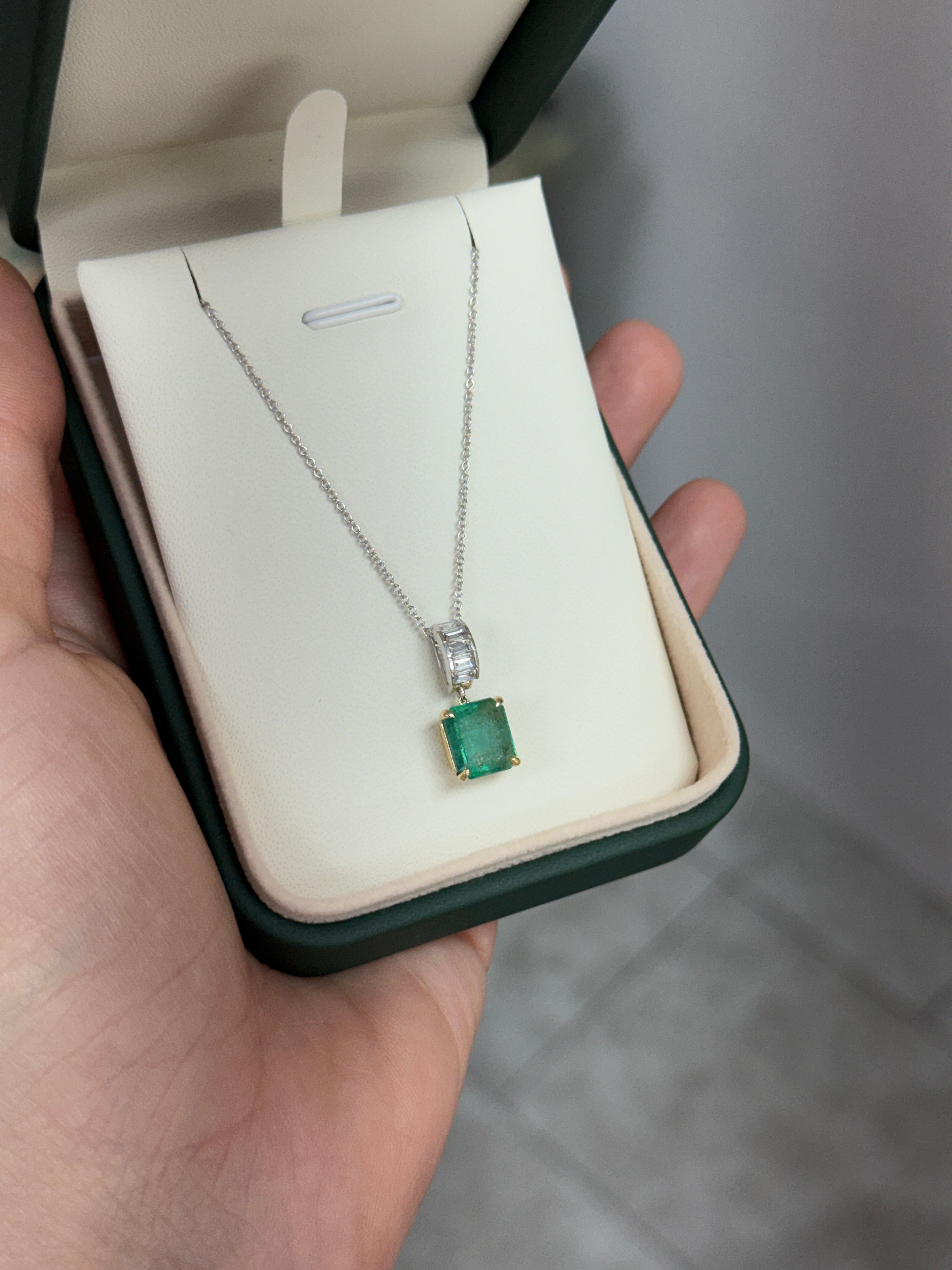 Asscher cut emerald and lab diamond bail pendant with 3.05tcw in 14K gold, featuring emerald and diamond baguette accents.