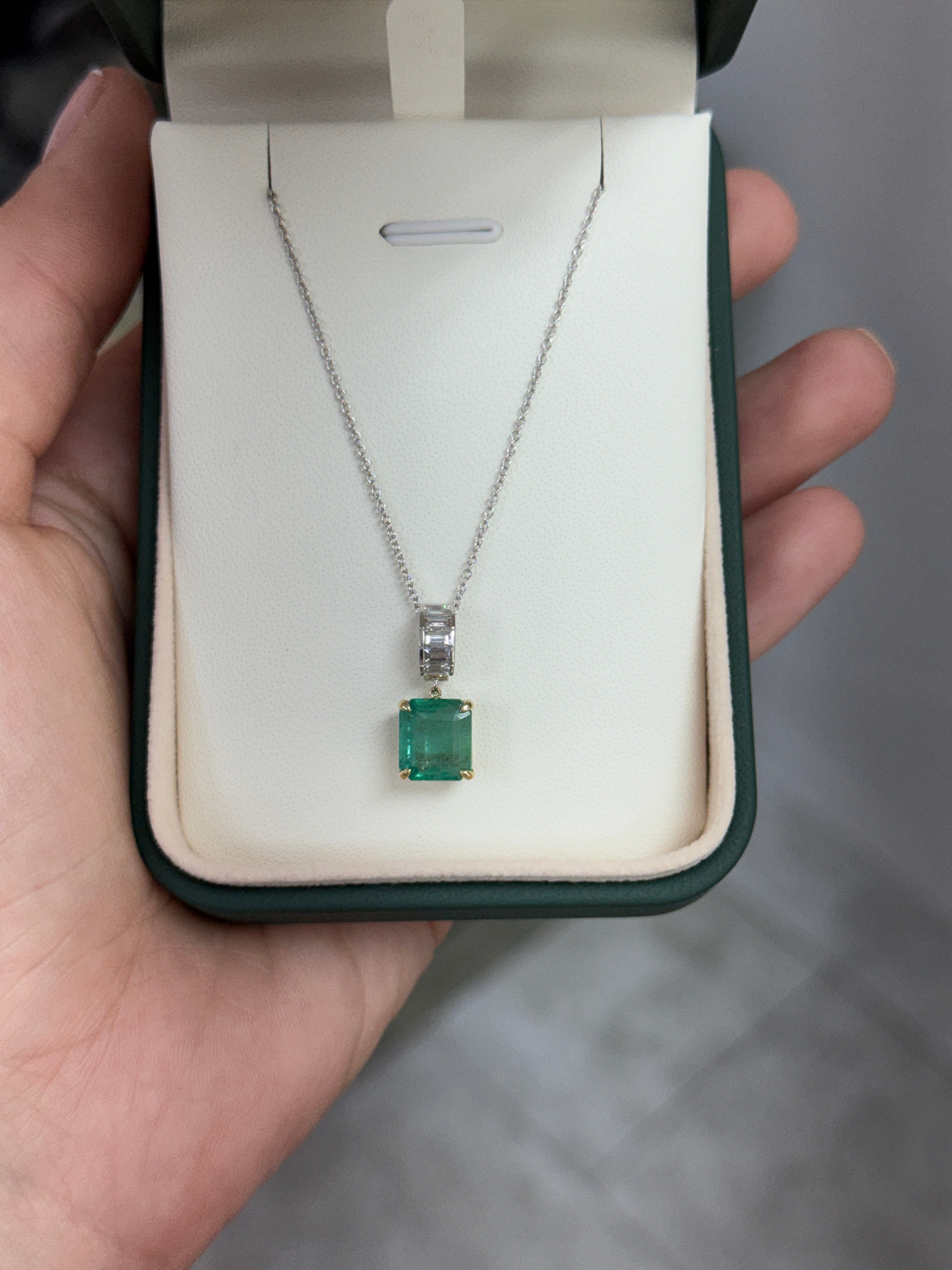Asscher cut emerald and lab diamond baguette bail pendant with 14K gold setting, featuring sparkling gemstones and intricate detailing.