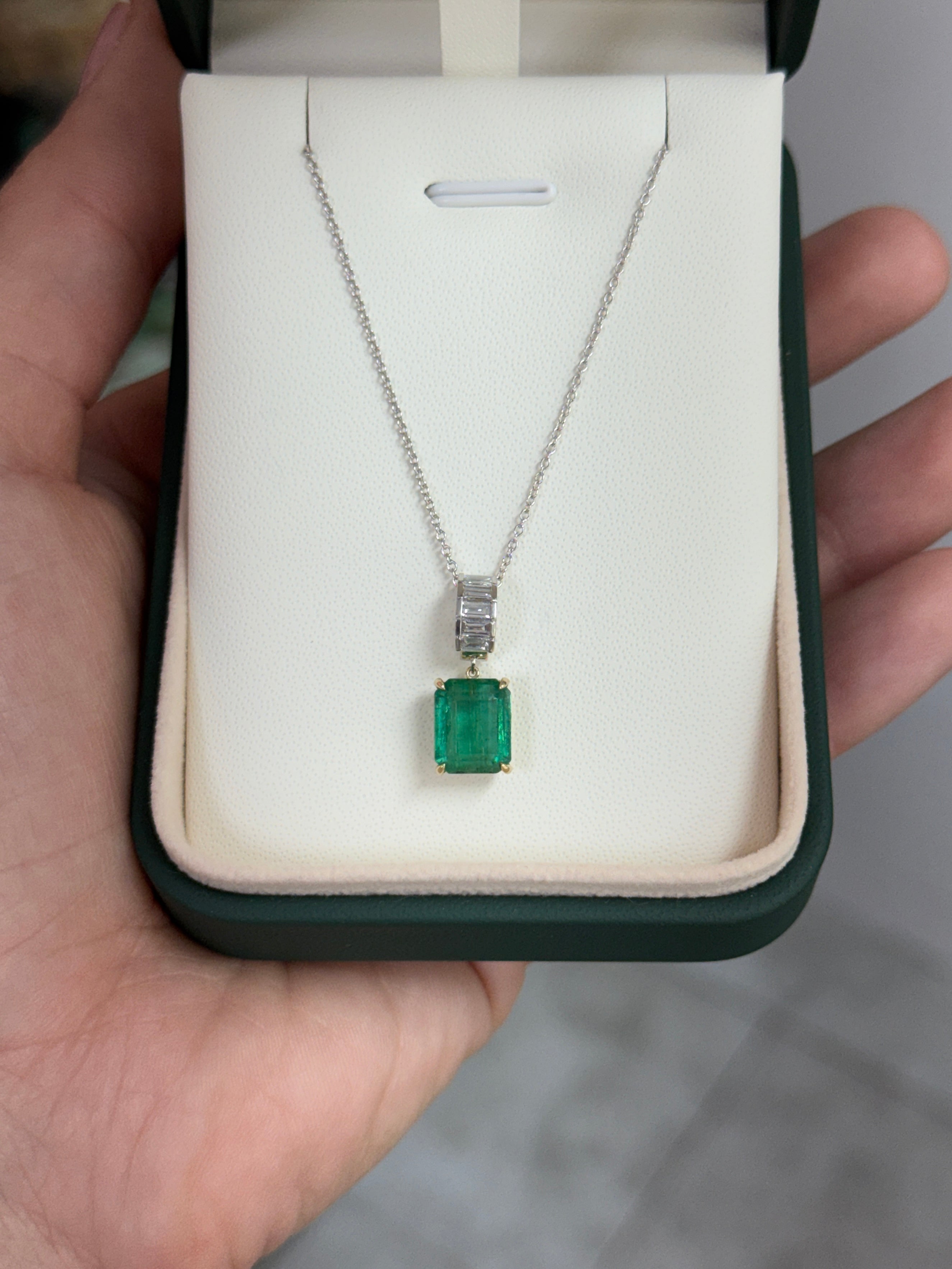 Natural emerald and lab diamond bail pendant with 3.57 tcw in 14K gold, featuring a classic design and baguette accents.