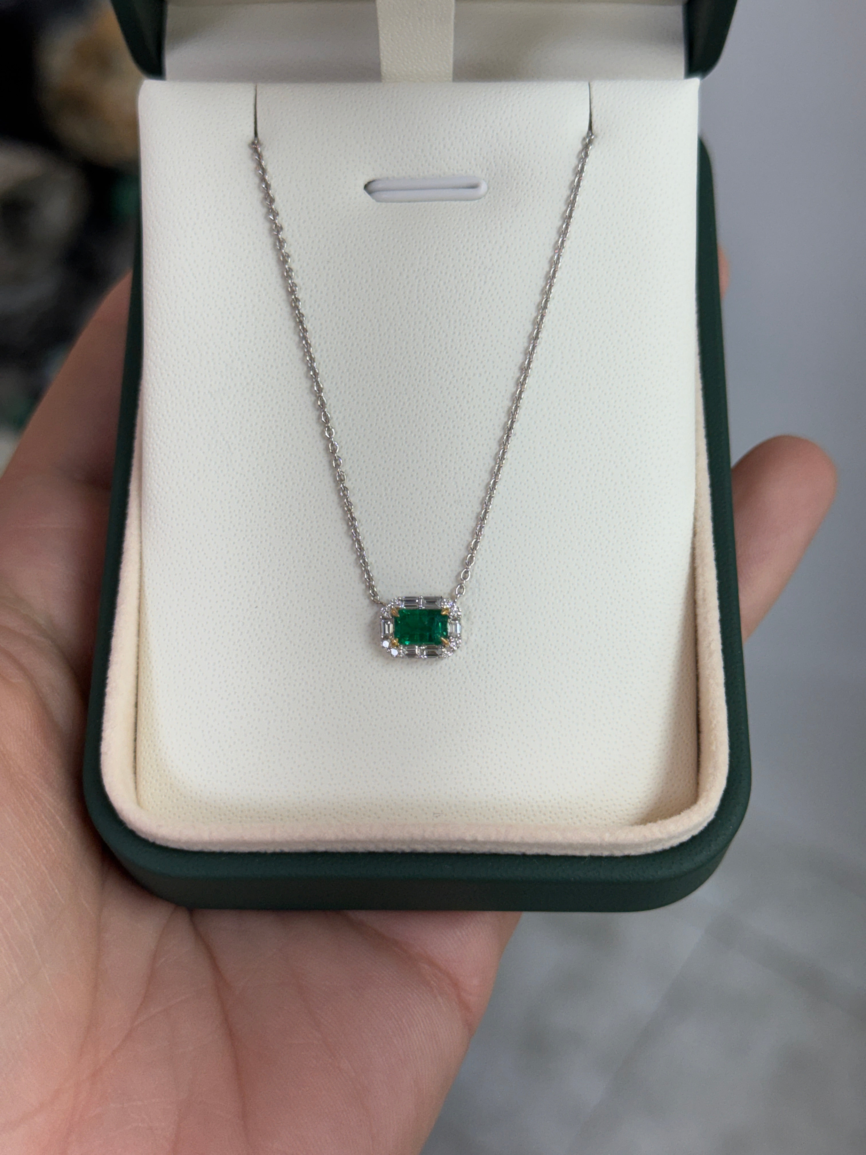 AAA+ natural emerald and baguette diamond halo necklace in 18K gold, east-to-west station design by JR Colombian Emeralds.