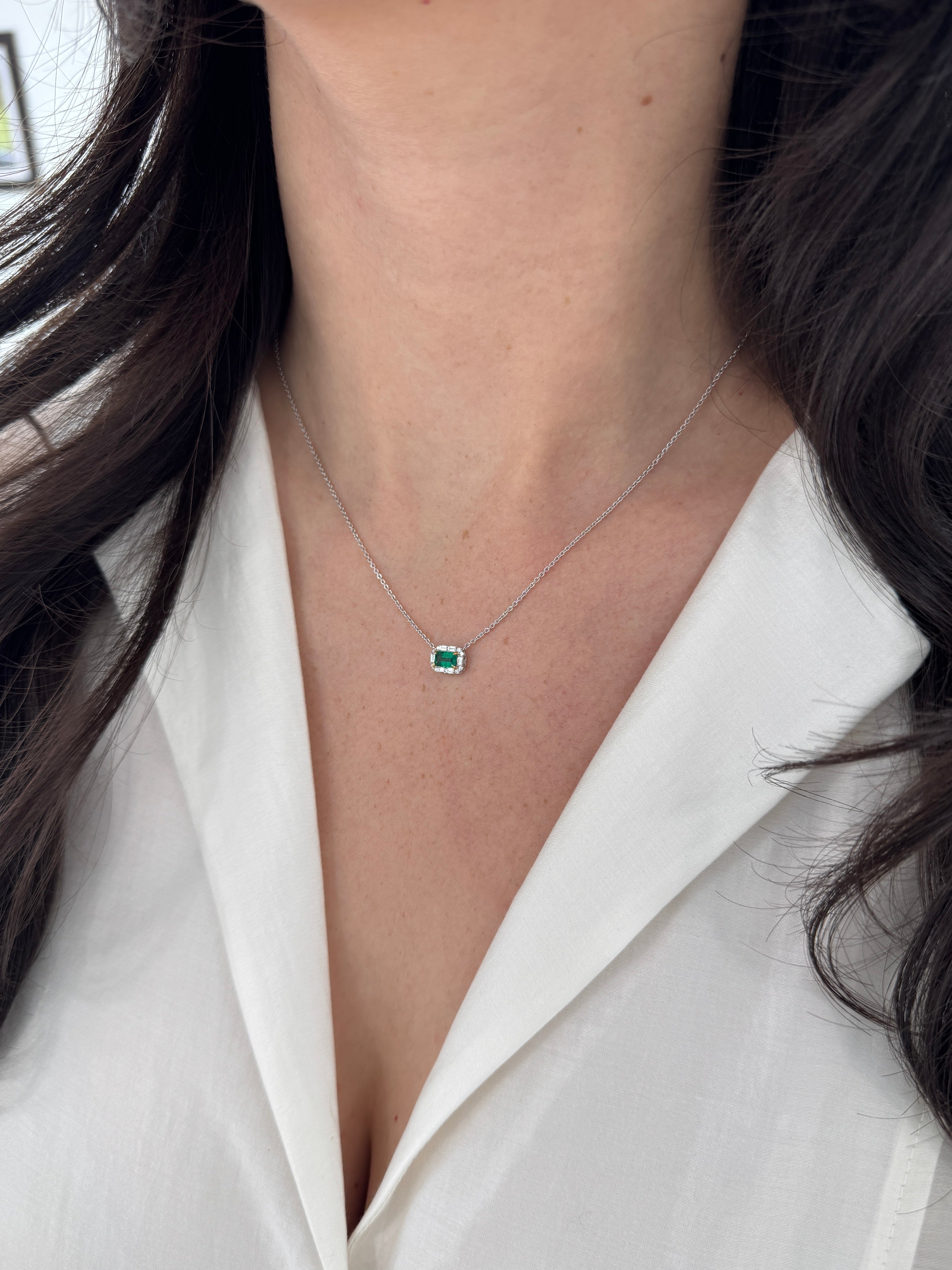AAA+ natural emerald and baguette diamond halo necklace with east-to-west station design in 18K gold, by JR Colombian Emeralds.