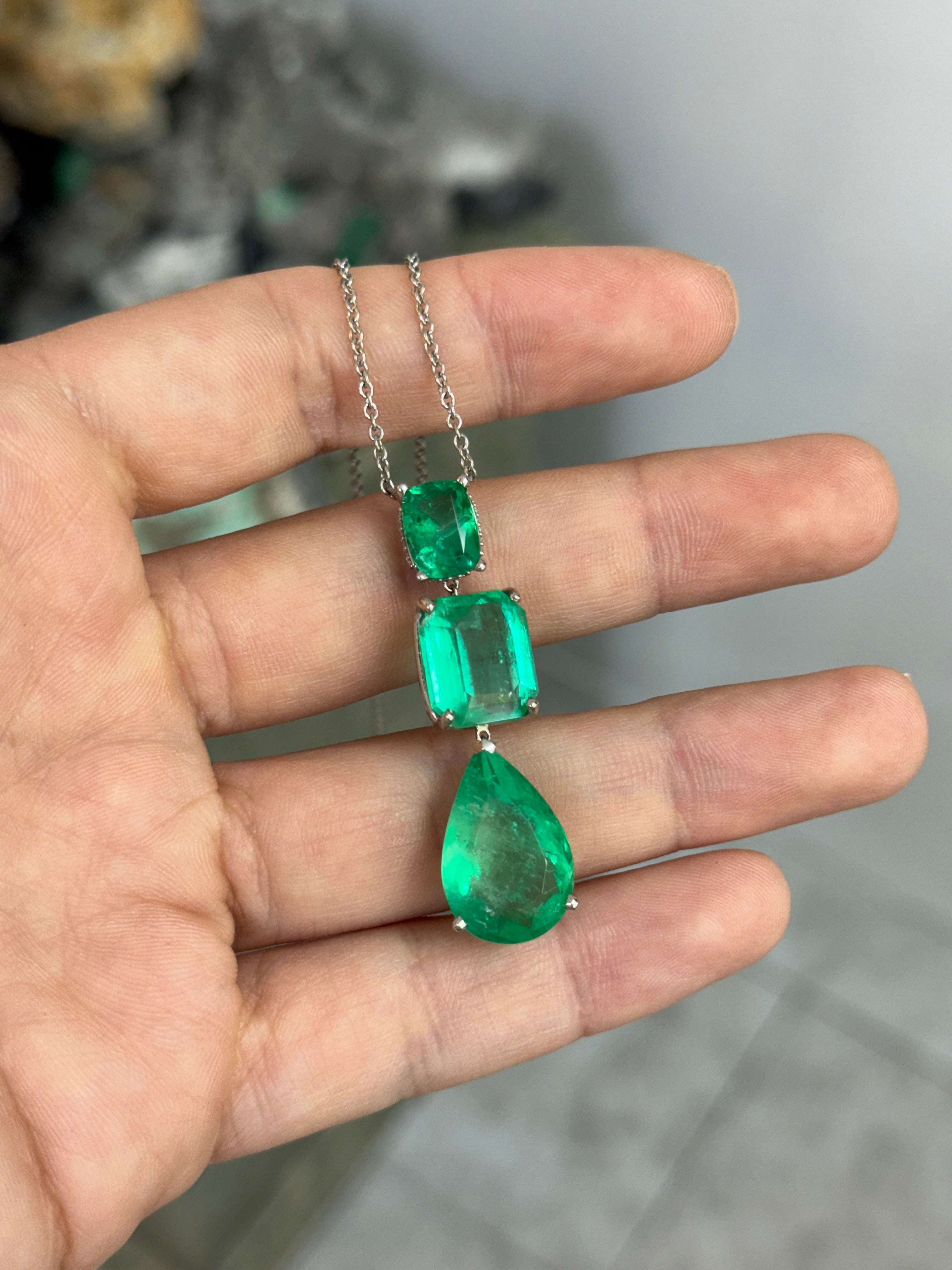 Colombian Emerald and diamond by the yard necklace featuring cushion-cut and pear-drop emeralds with platinum setting.