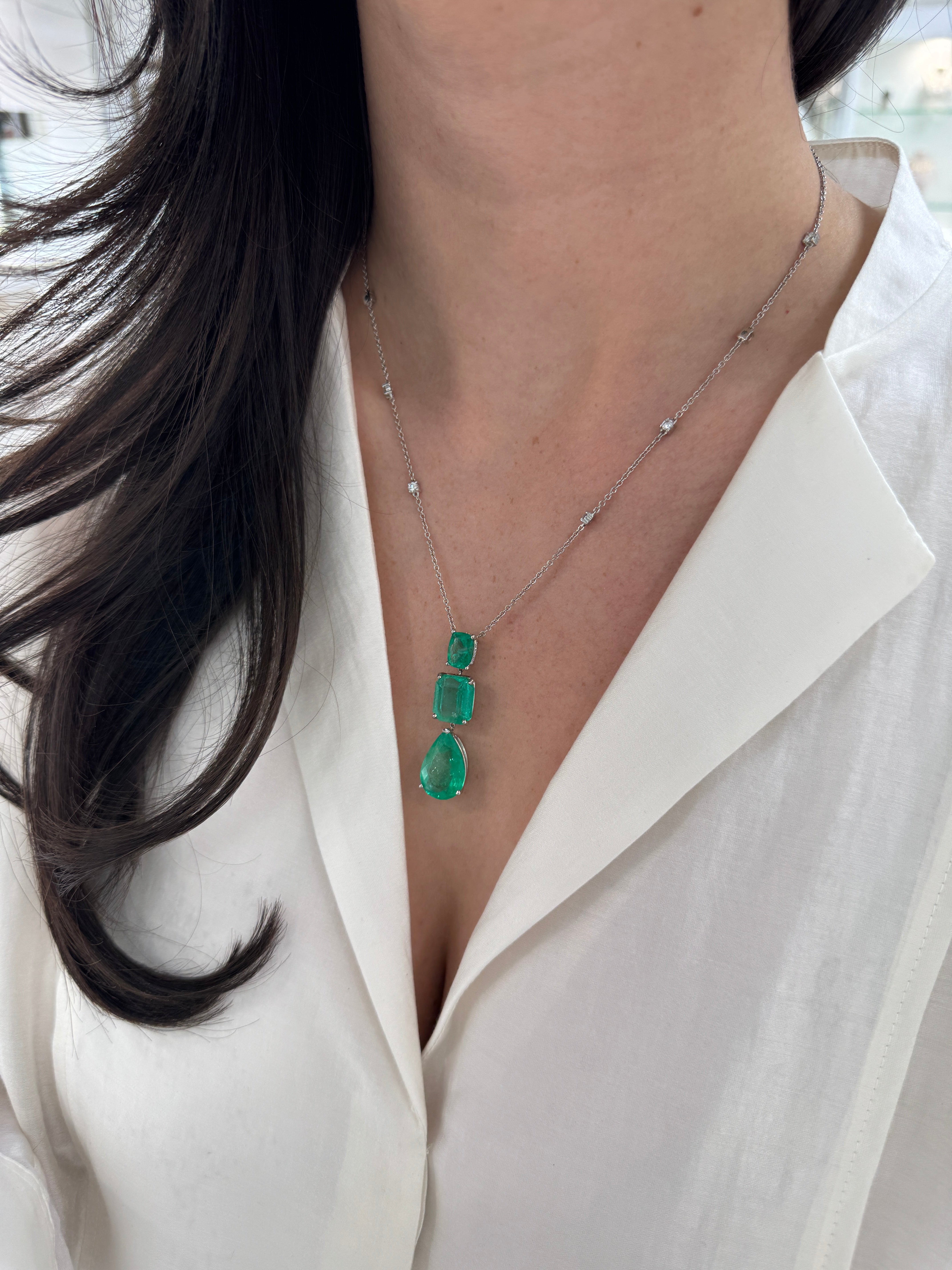 Colombian emerald and diamond by the yard necklace featuring cushion and pear drop emerald cuts in platinum, showcasing sparkling gemstones.
