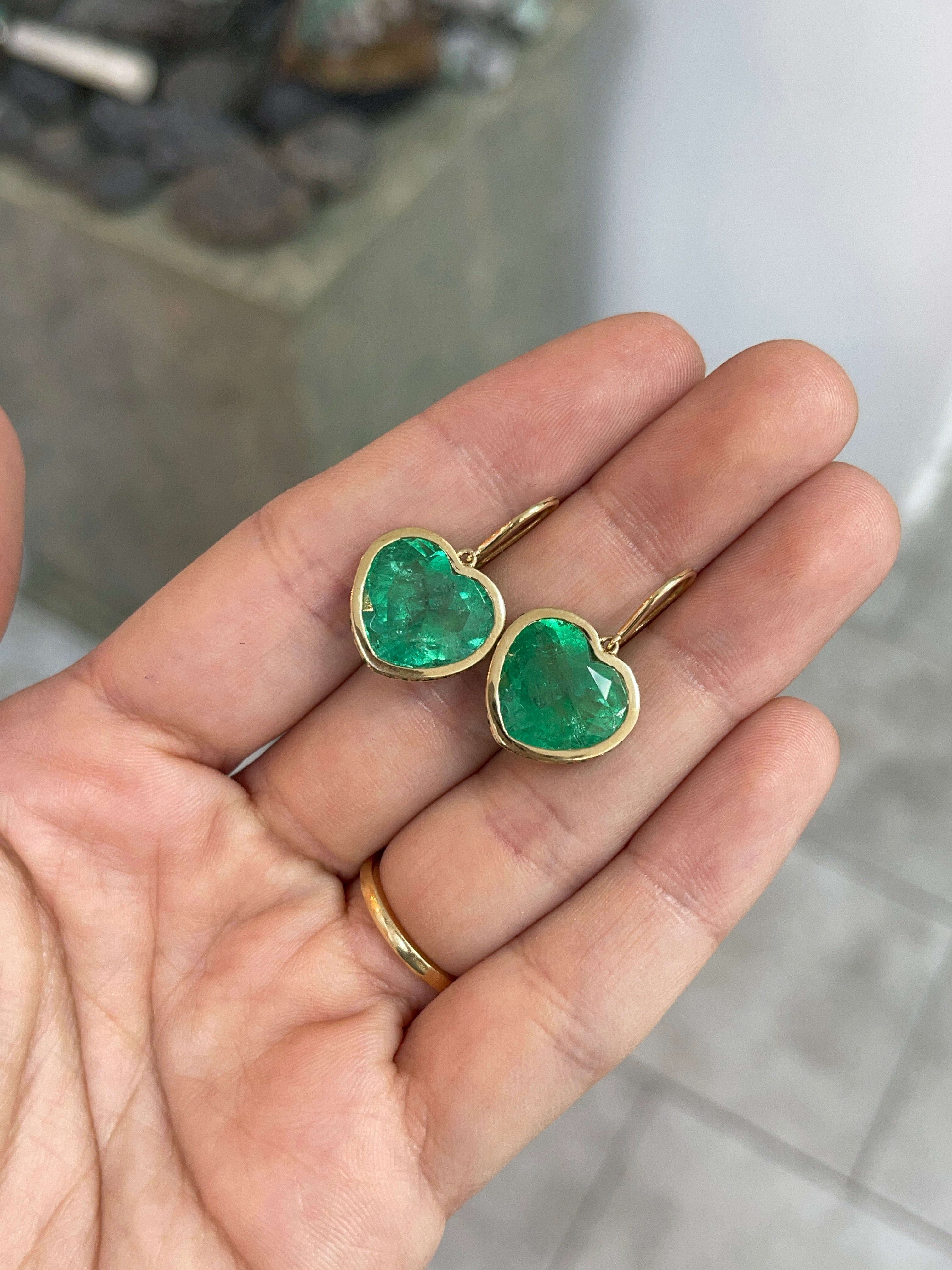 18K gold dangle earrings with 17.40tcw heart-shaped Colombian emeralds and ombre diamond and emerald bezel settings.