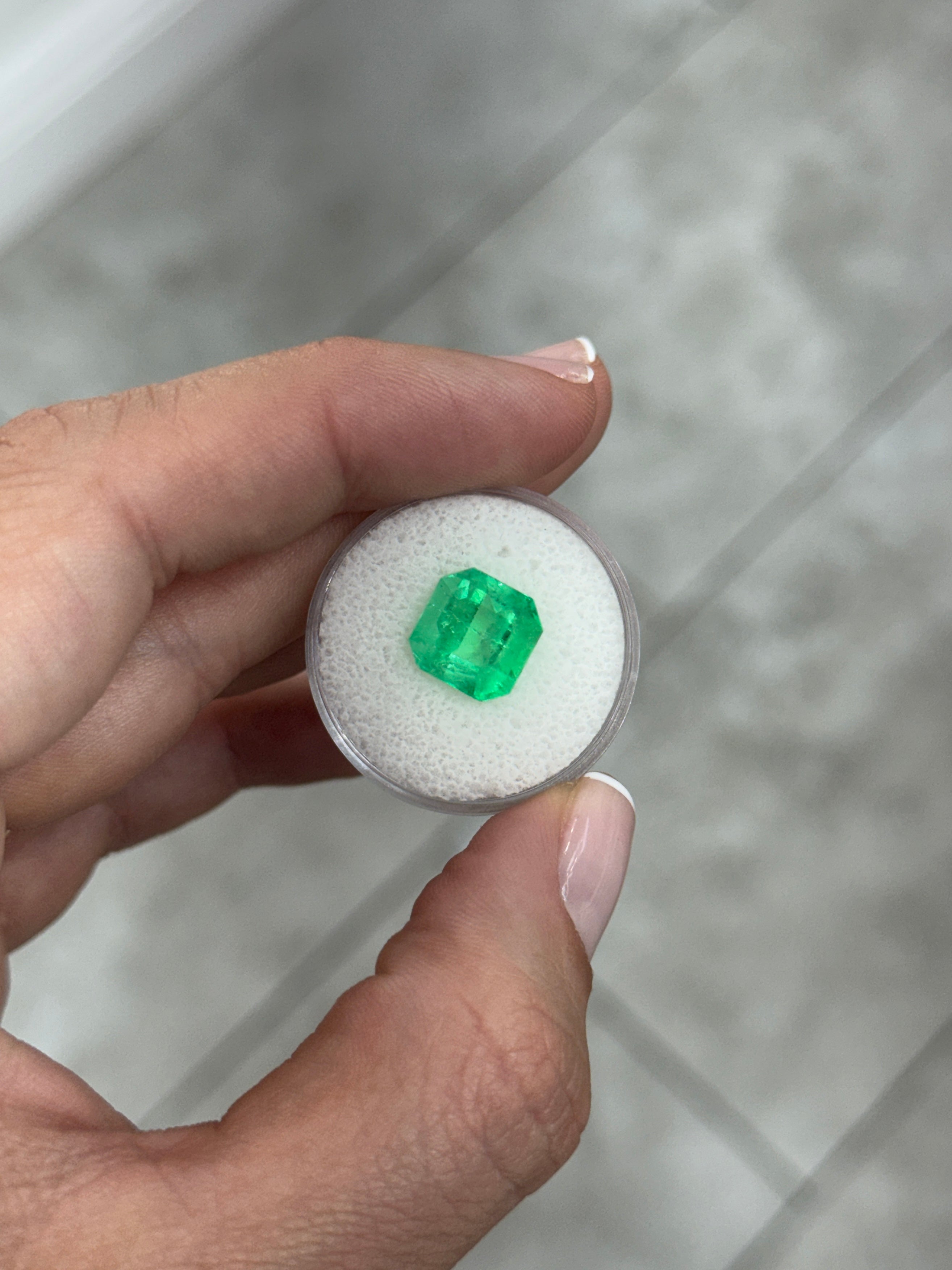 4.57 carat 10x10mm Colombian emerald Asscher cut with clipped corners, glowing and vibrant, from JR Colombian Emeralds.