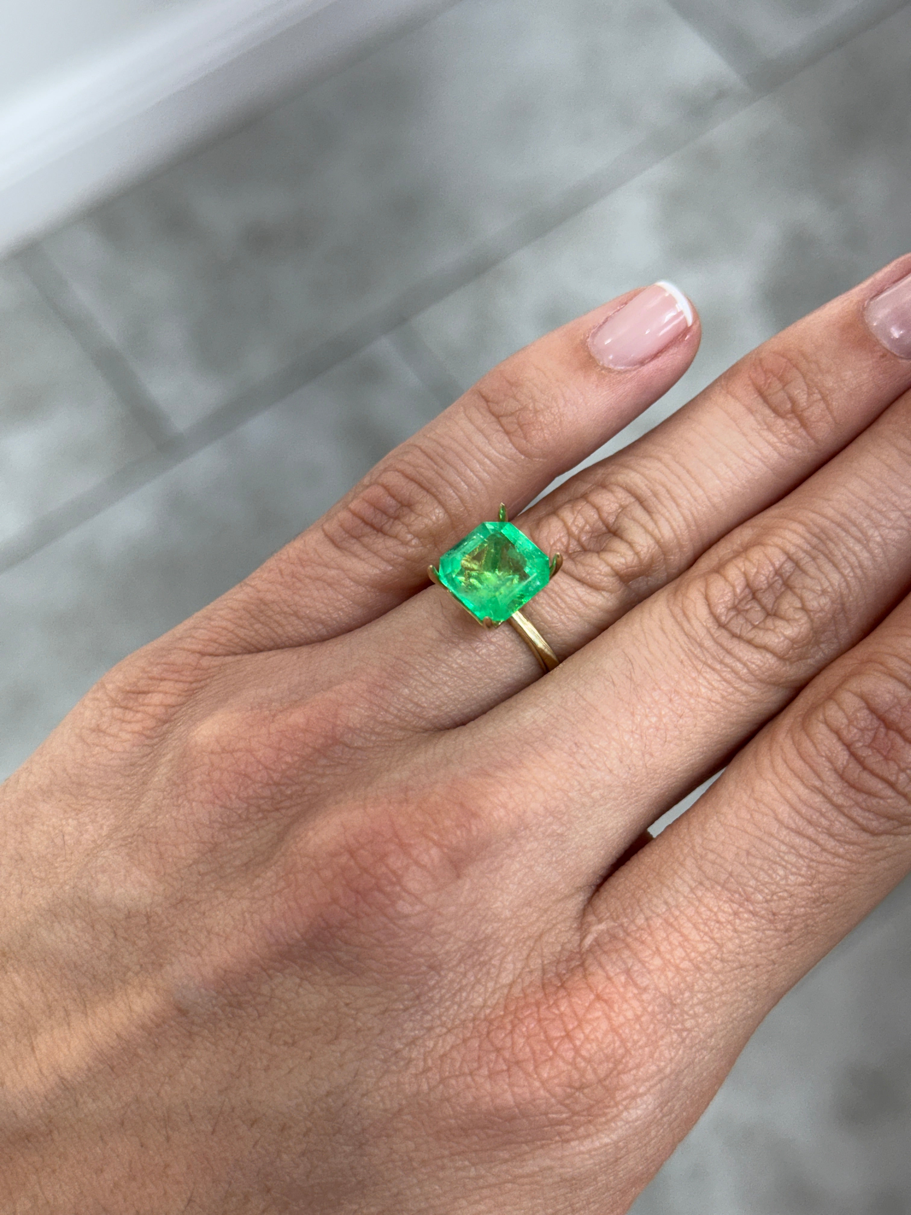 4.57 carat 10x10 mm Colombian emerald Asscher cut with clipped corners, glowing loose gemstone from JR Colombian Emeralds.
