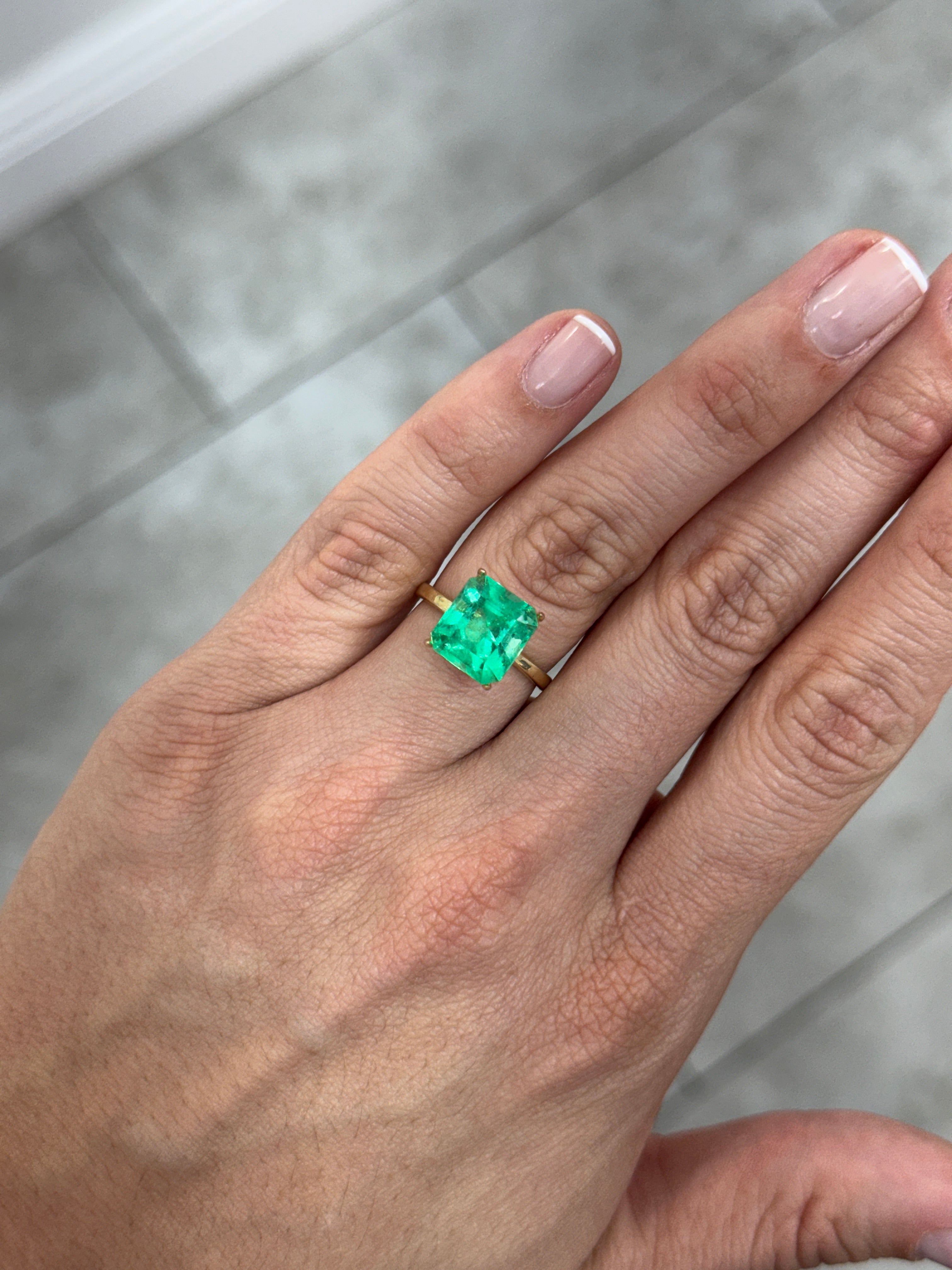 Natural 4.75 carat 11x10mm bluish green Colombian emerald loose Asscher cut showcasing vibrant color and clarity.
