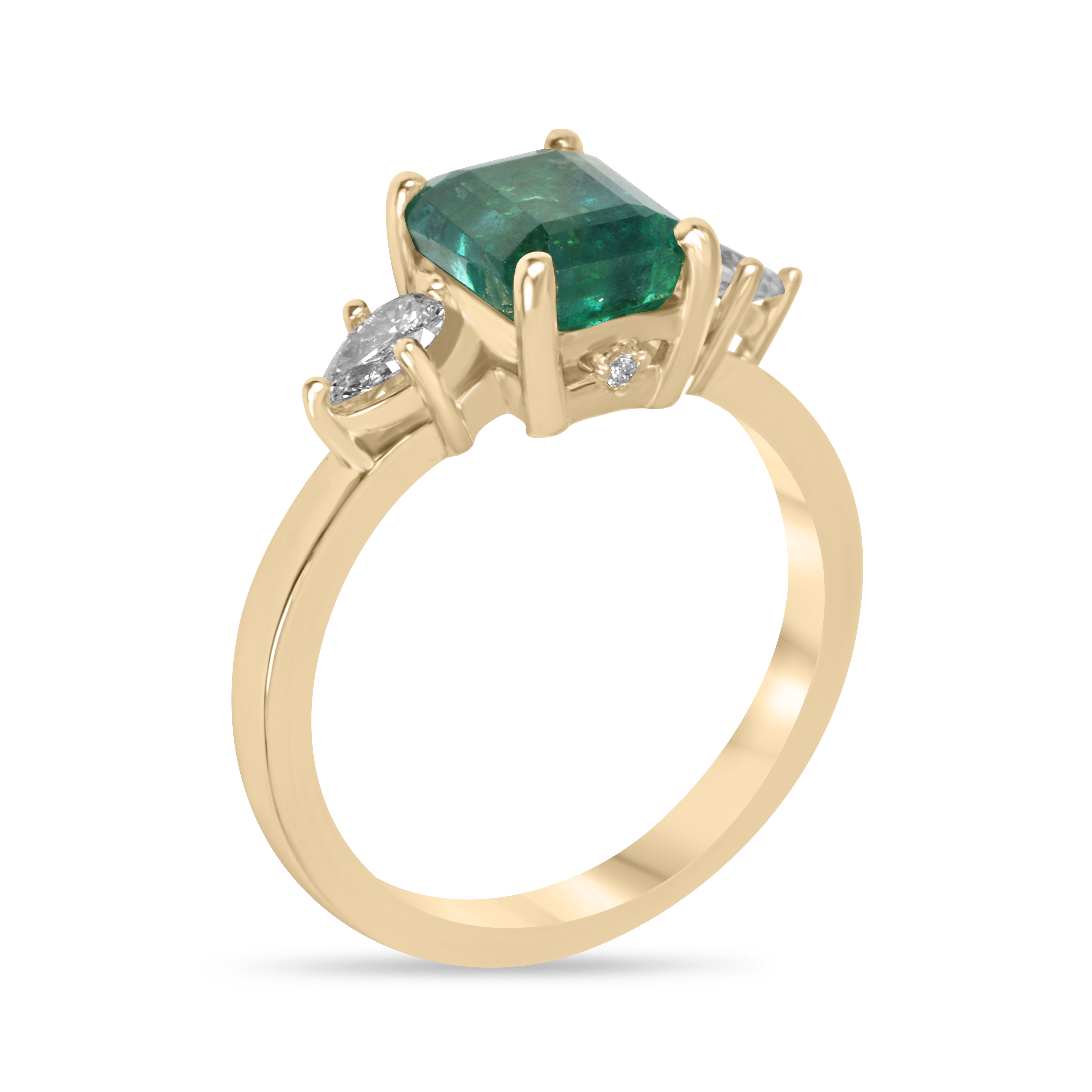 Emerald cut emerald and pear-shaped diamonds three-stone ring with hidden diamond accents in 18K gold by JR Colombian Emeralds.