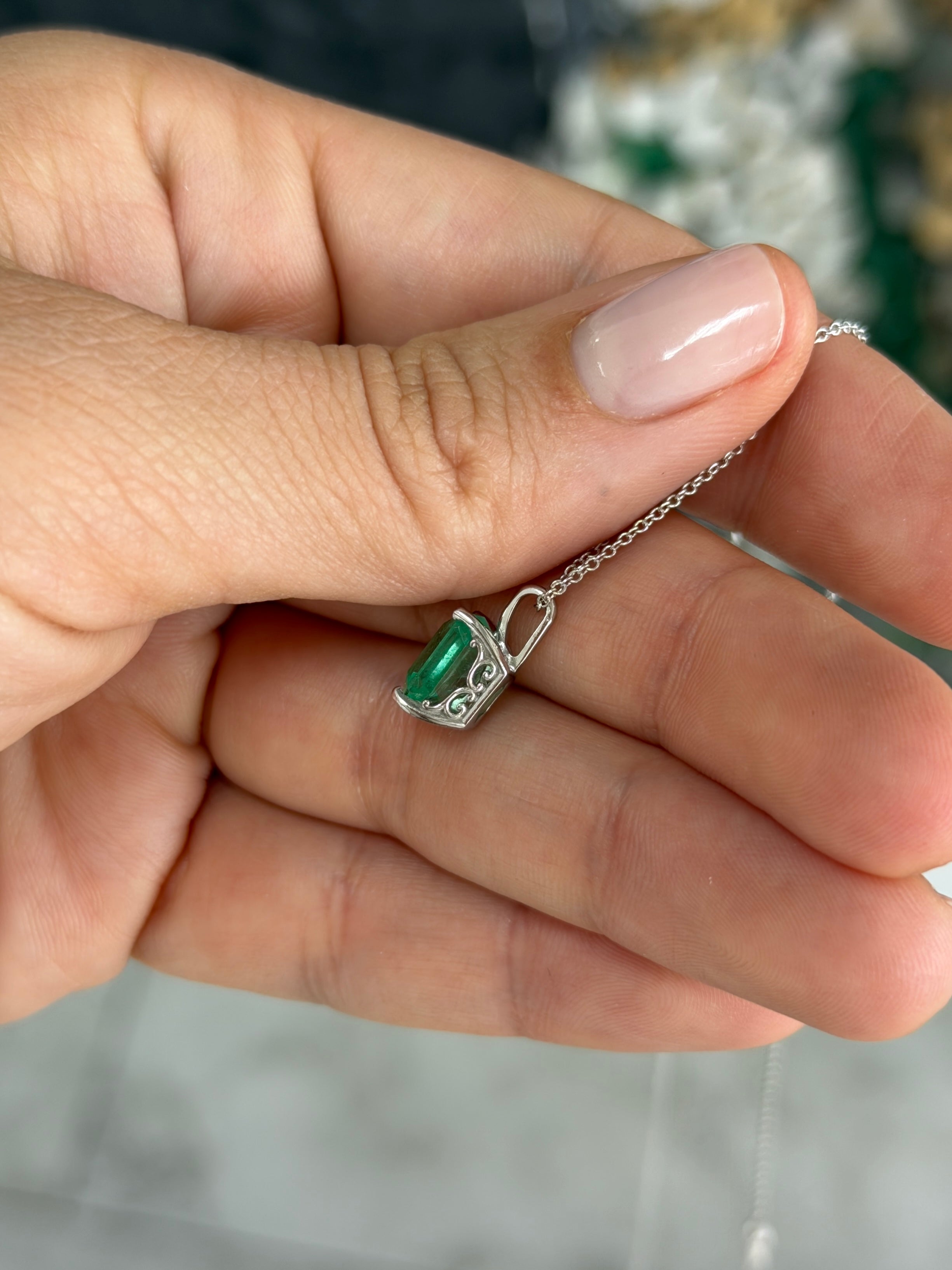 14K white gold Colombian emerald fleur de lis solitaire necklace featuring a 2.20 carat emerald pendant.