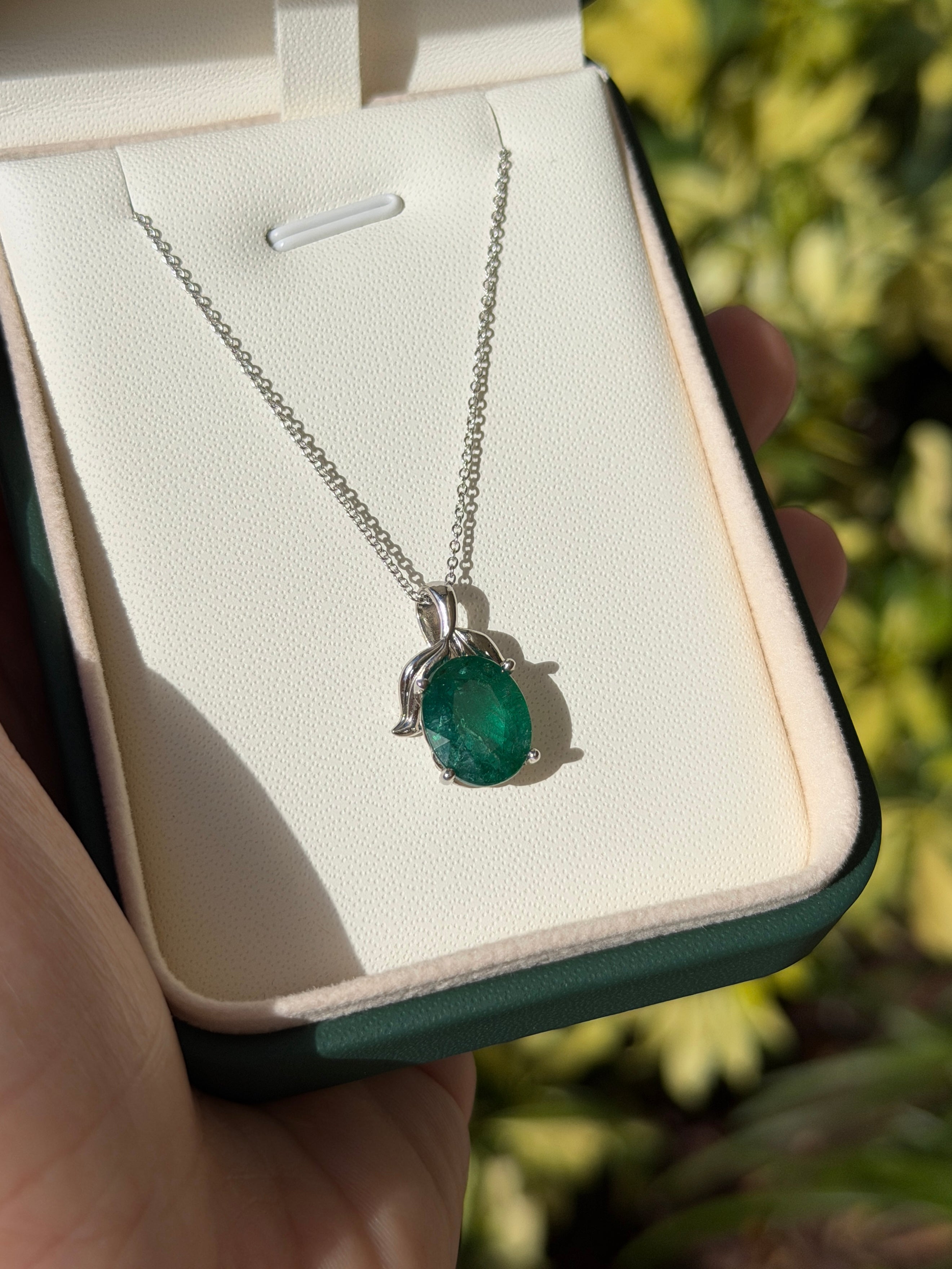 3.23 carat oval cut emerald pendant with leaf bail on platinum chain, natural-inspired emerald necklace by JR Colombian Emeralds