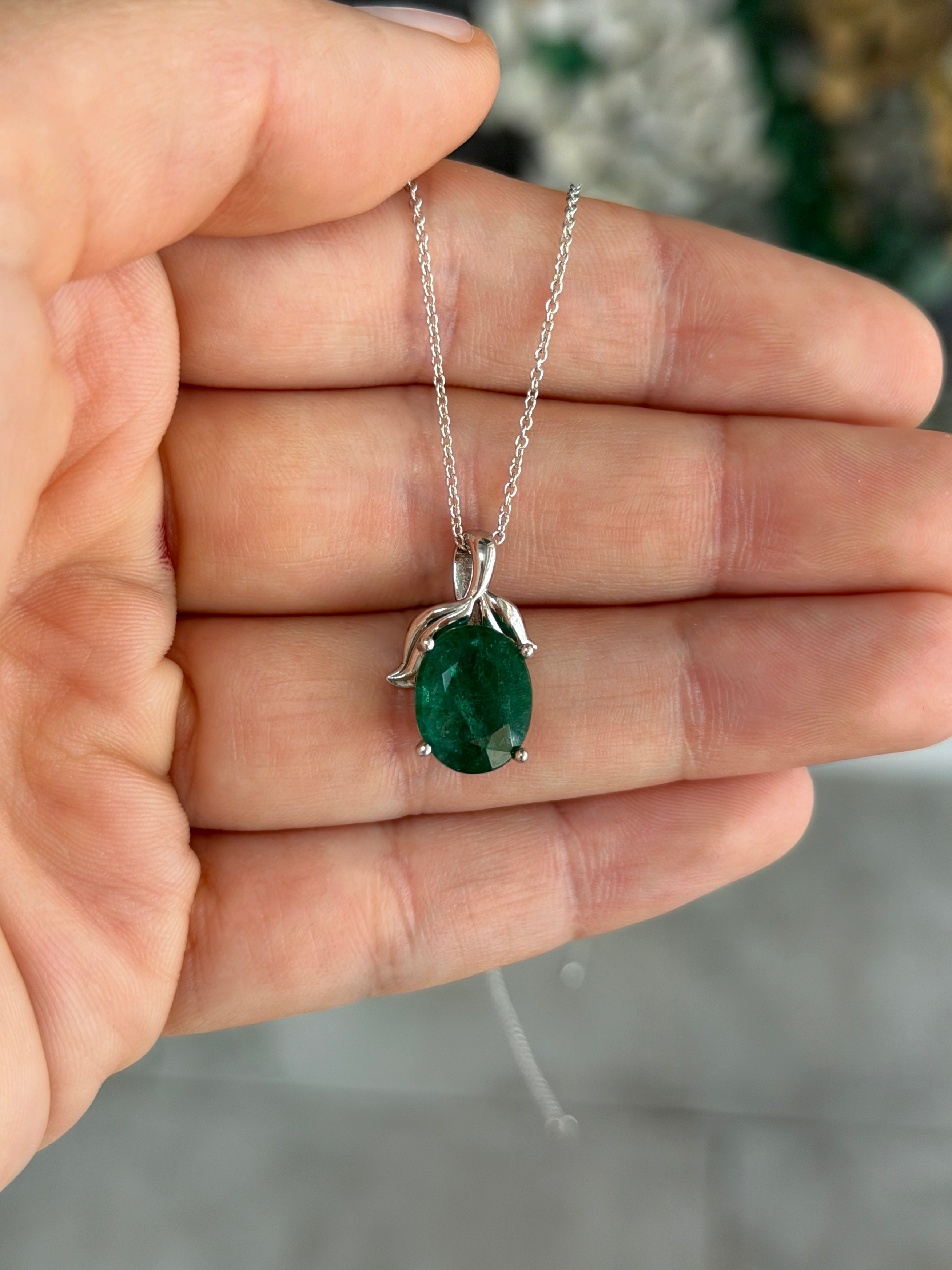 3.23 carat oval cut emerald pendant with leaf design and platinum setting, inspired by nature, from JR Colombian Emeralds.