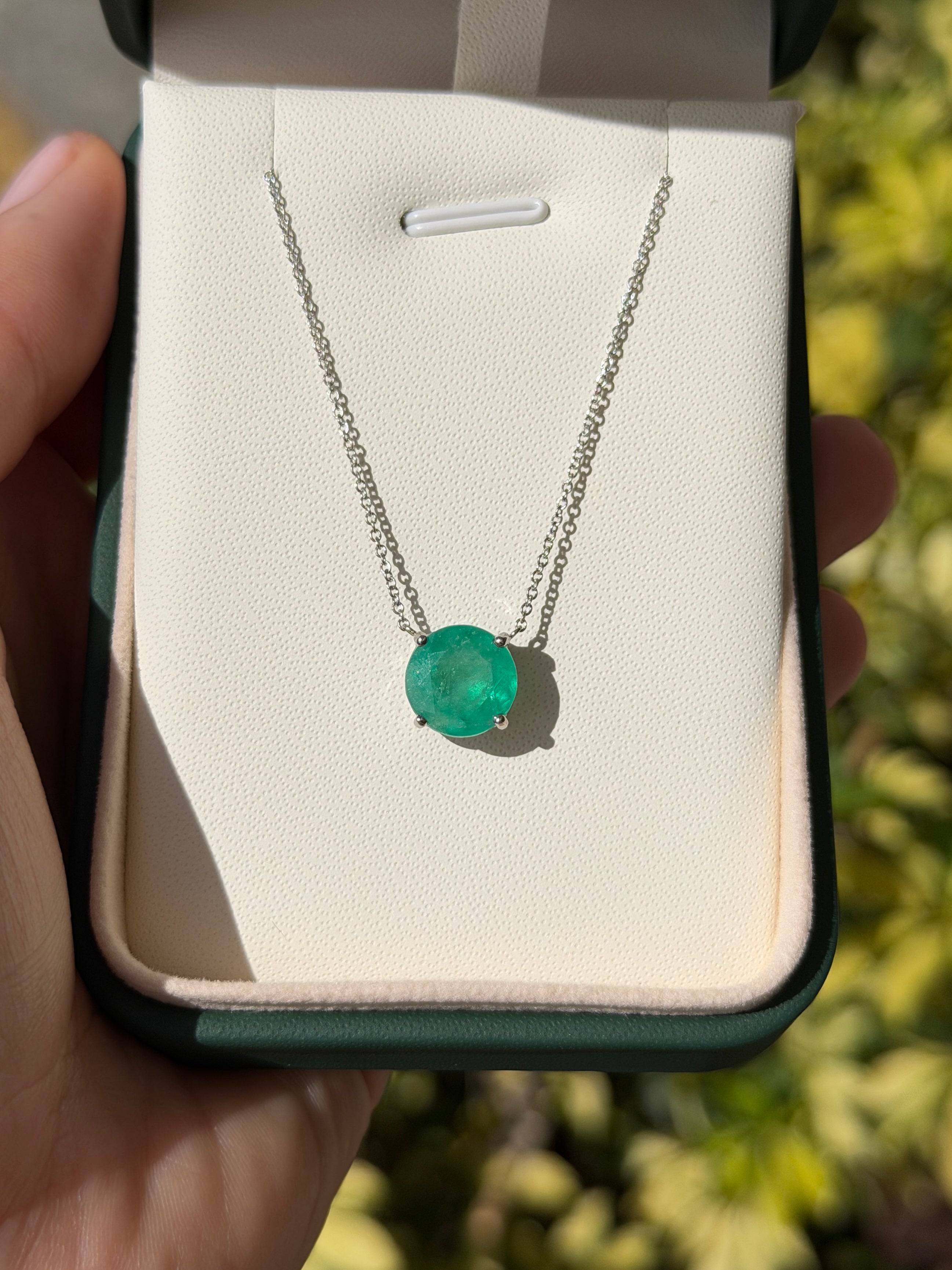 Natural round Colombian emeralds in an 18K gold stationary necklace by JR Colombian Emeralds.