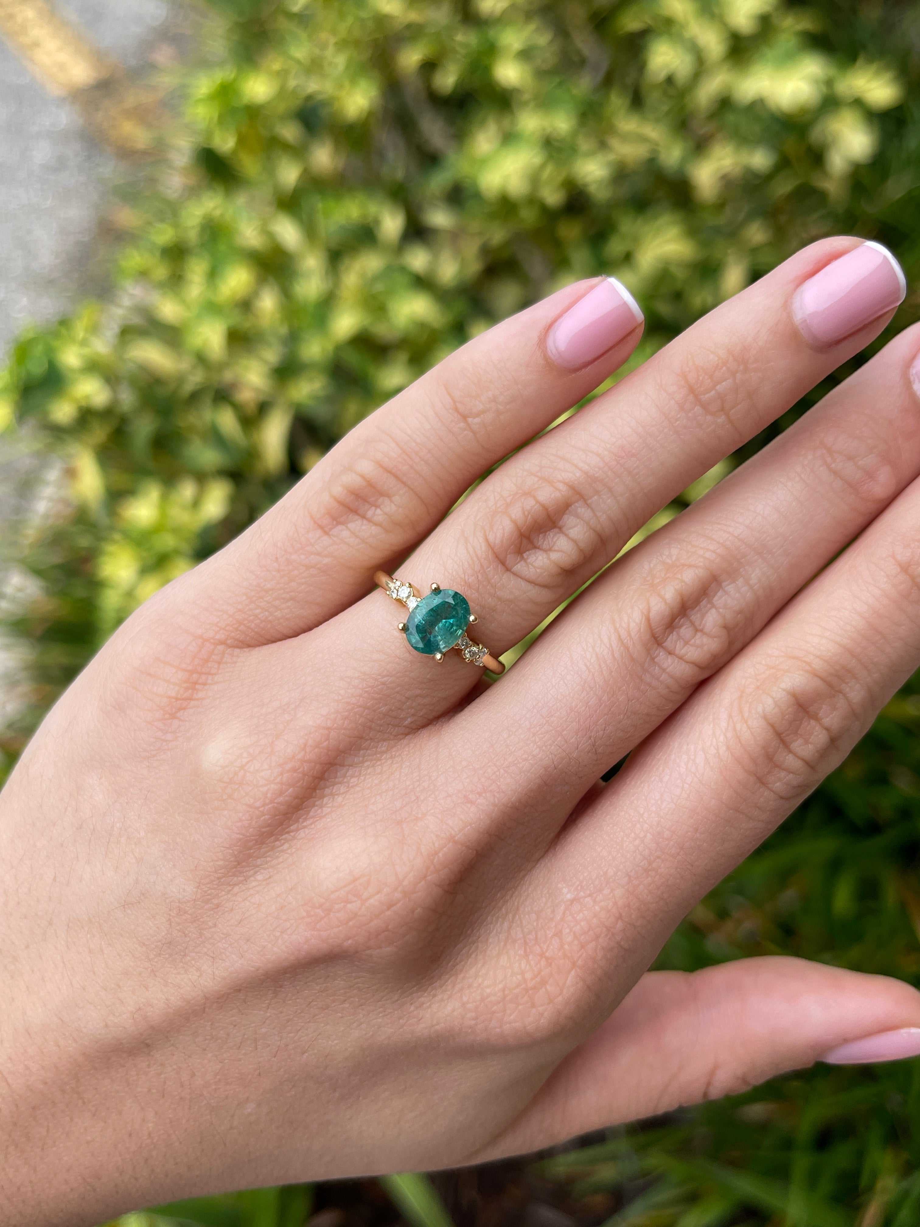 18K gold oval cut emerald and diamond constellation accent right hand ring by JR Colombian Emeralds, close-up view.