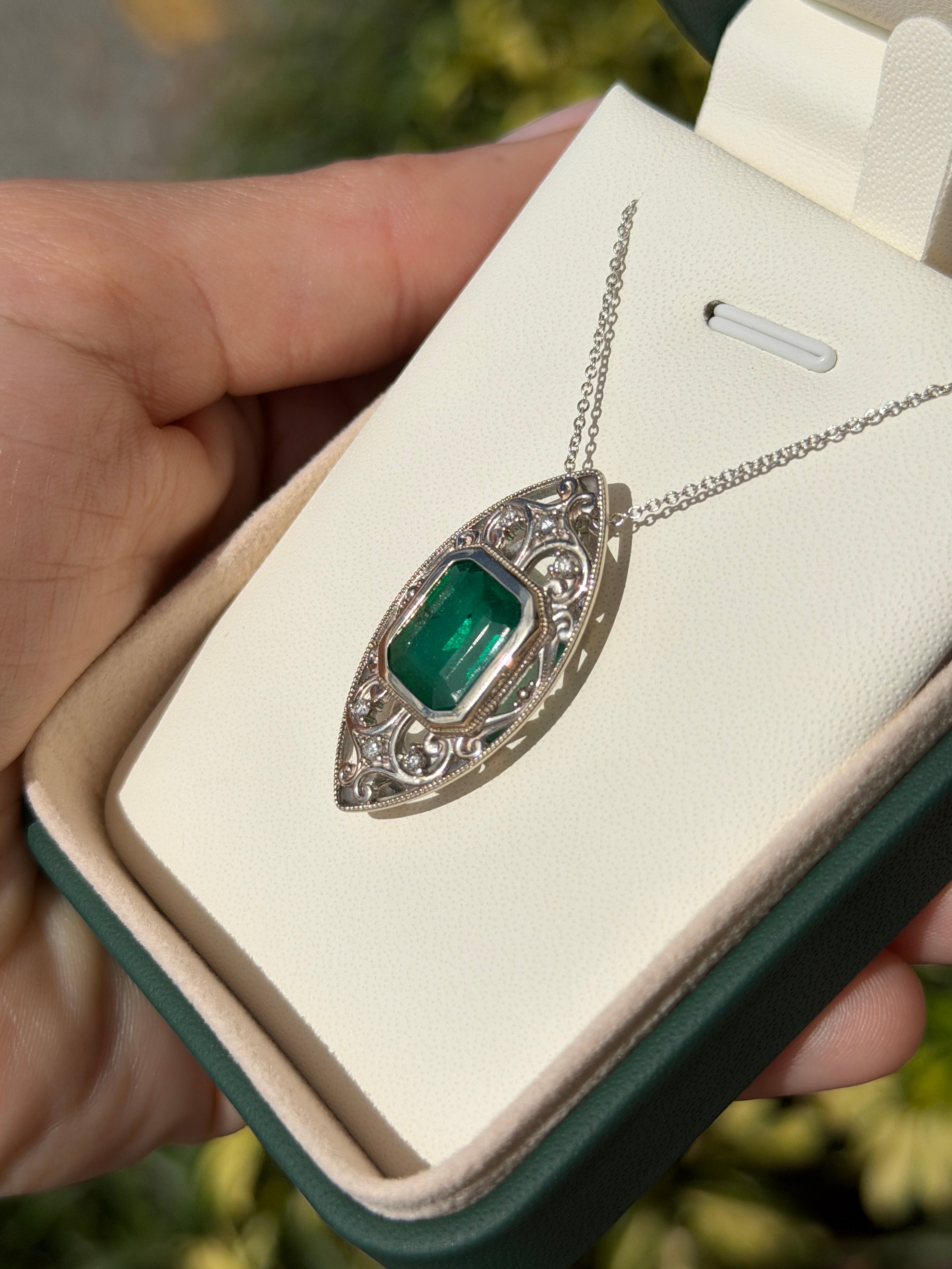 Art Deco-inspired emerald cut emerald diamond slider necklace with vintage filigree design in 14K gold, by JR Colombian Emeralds.