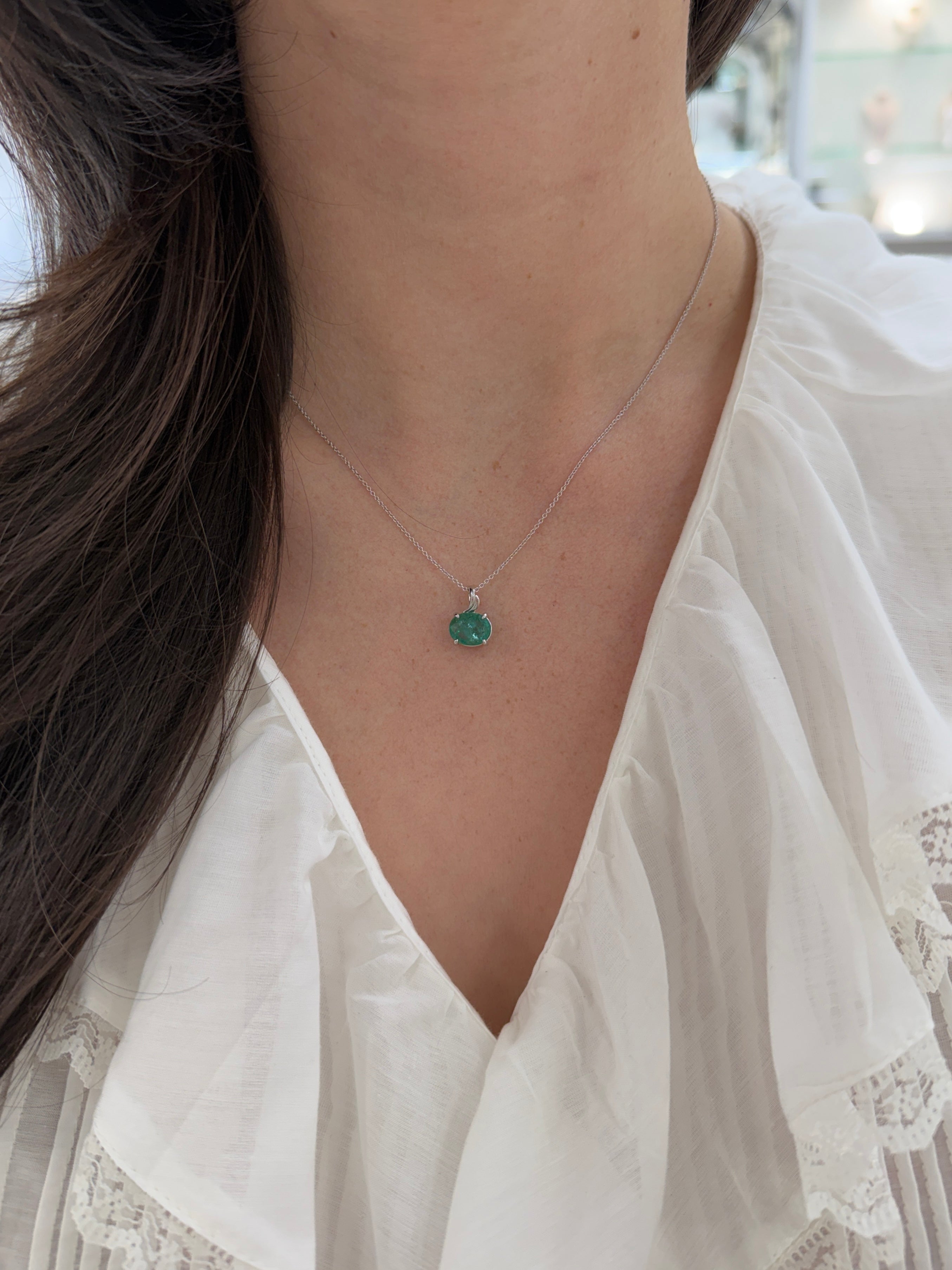 Earthy 2.60ct east-west oval emerald pendant necklace in 14K white gold with leaf design, from JR Colombian Emeralds.