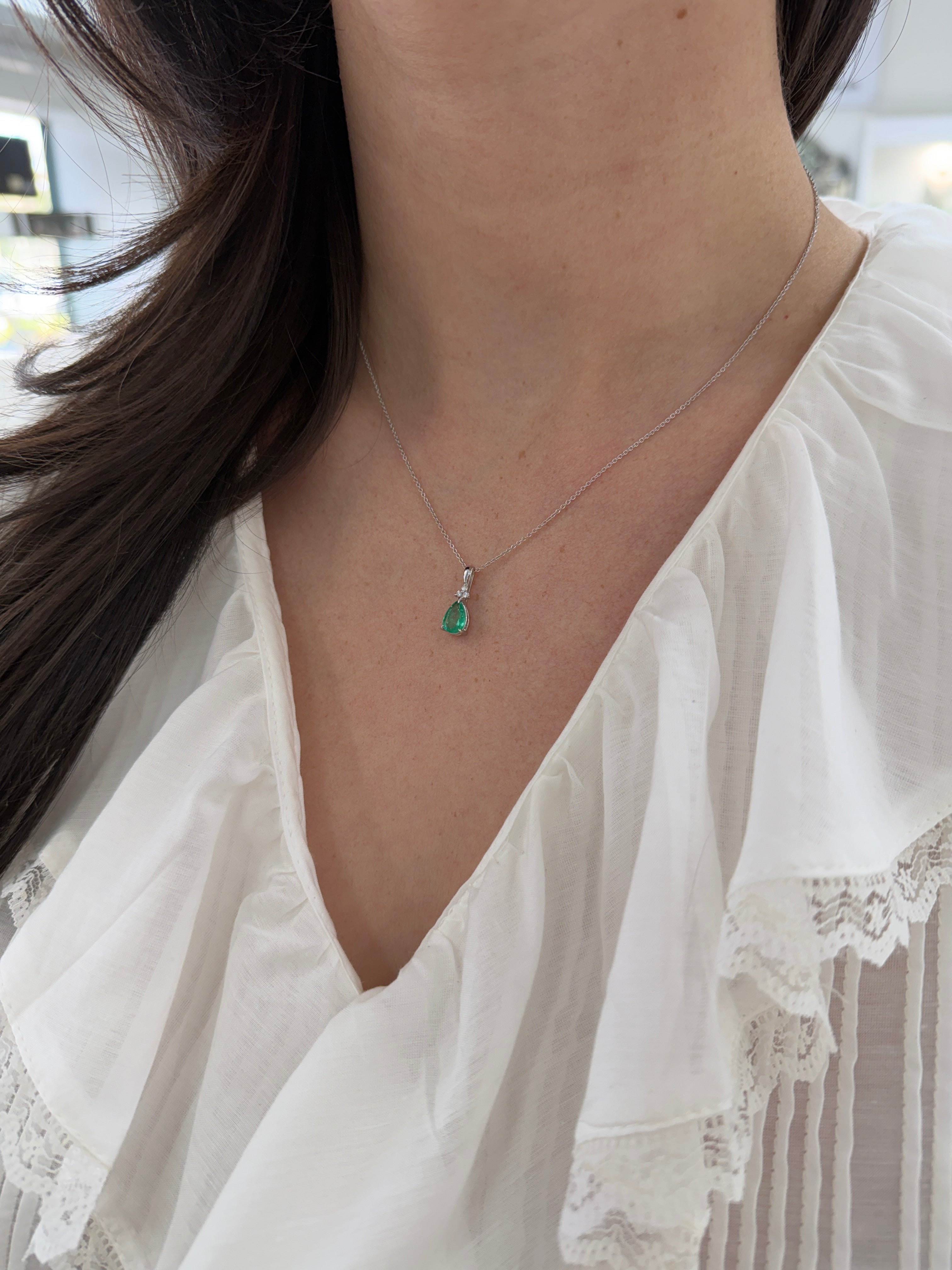 Pear-shaped emerald drop pendant with trefoil diamond cluster in 14K white gold by JR Colombian Emeralds.