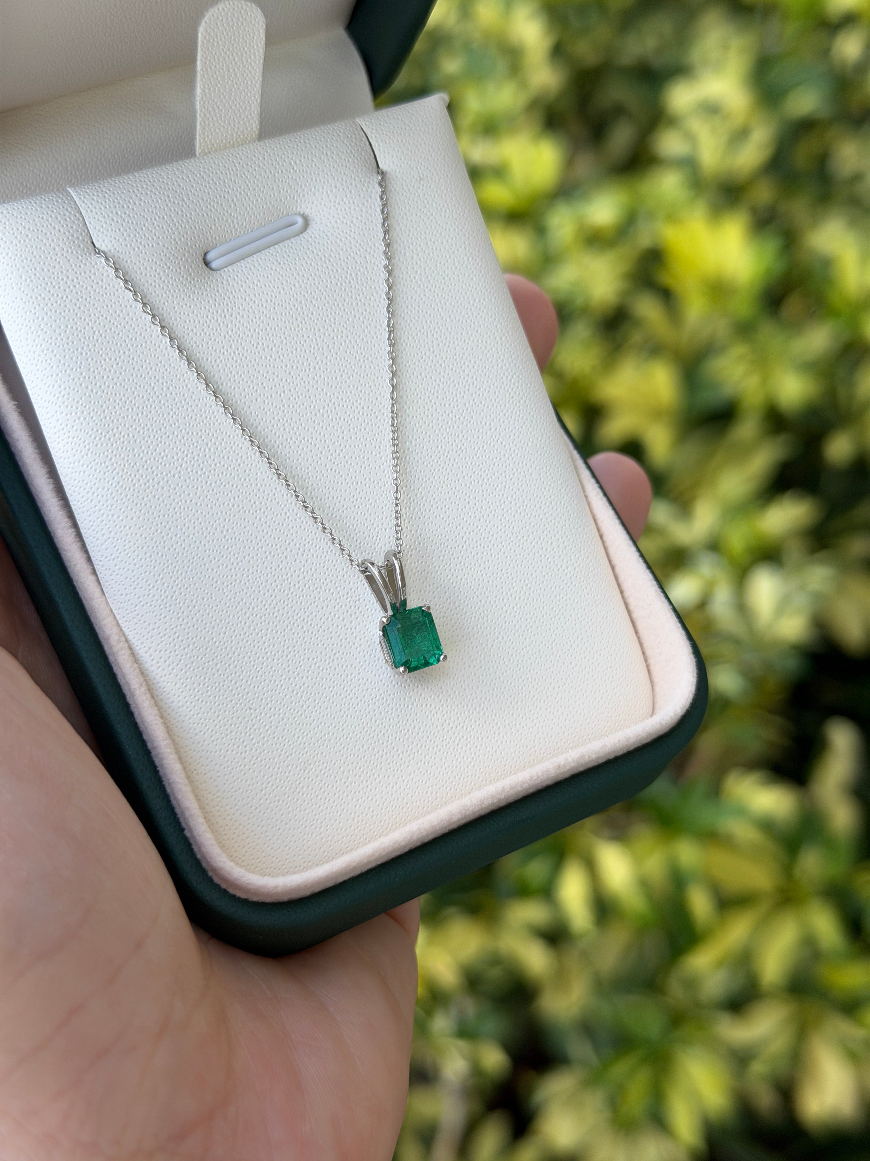 Green Asscher cut emerald solitaire necklace with 2.10ct platinum setting, high-quality jewelry by JR Colombian Emeralds.