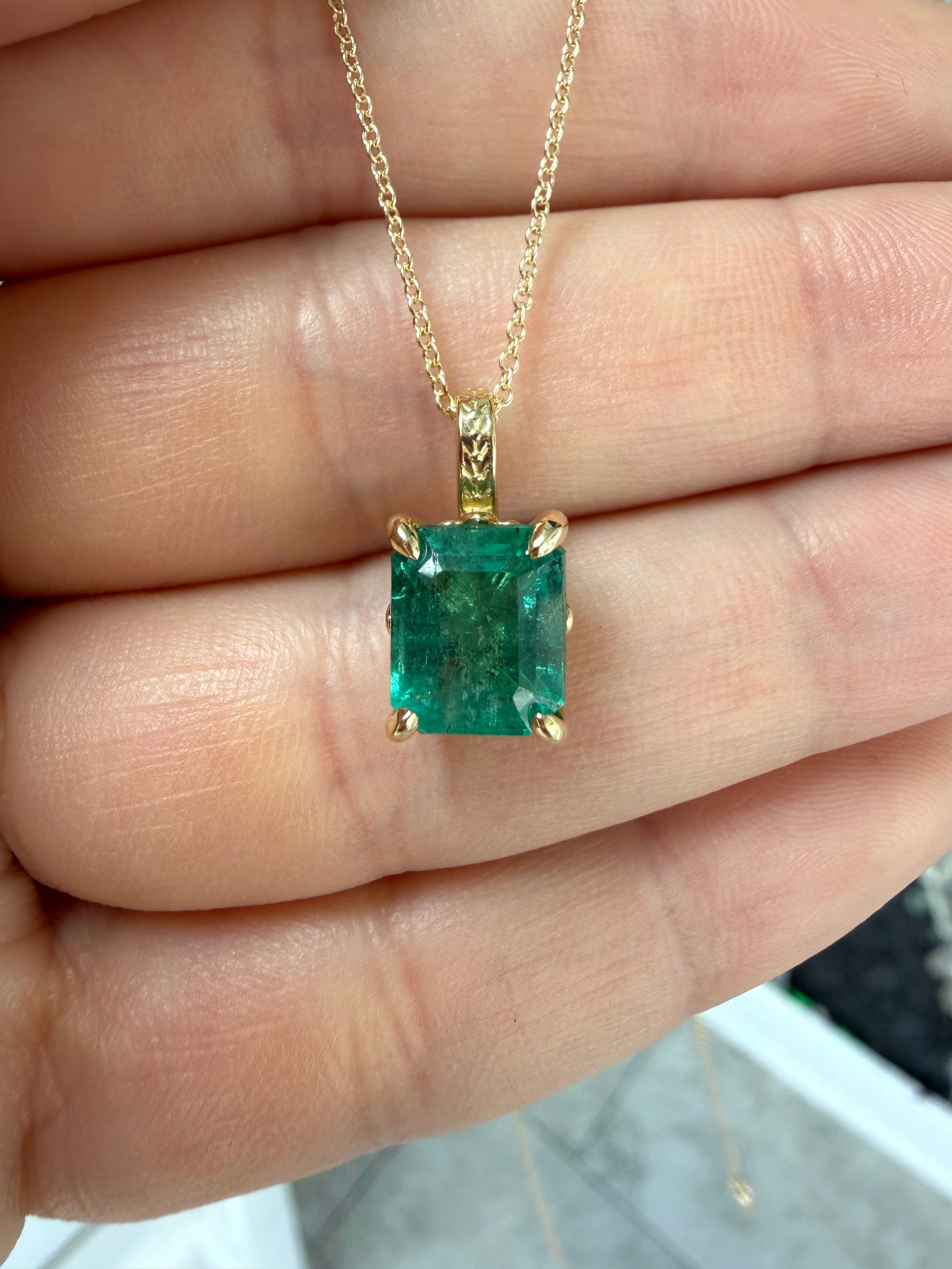 14K gold solitaire necklace featuring a 3.50 carat emerald with fleur de lis design by JR Colombian Emeralds.