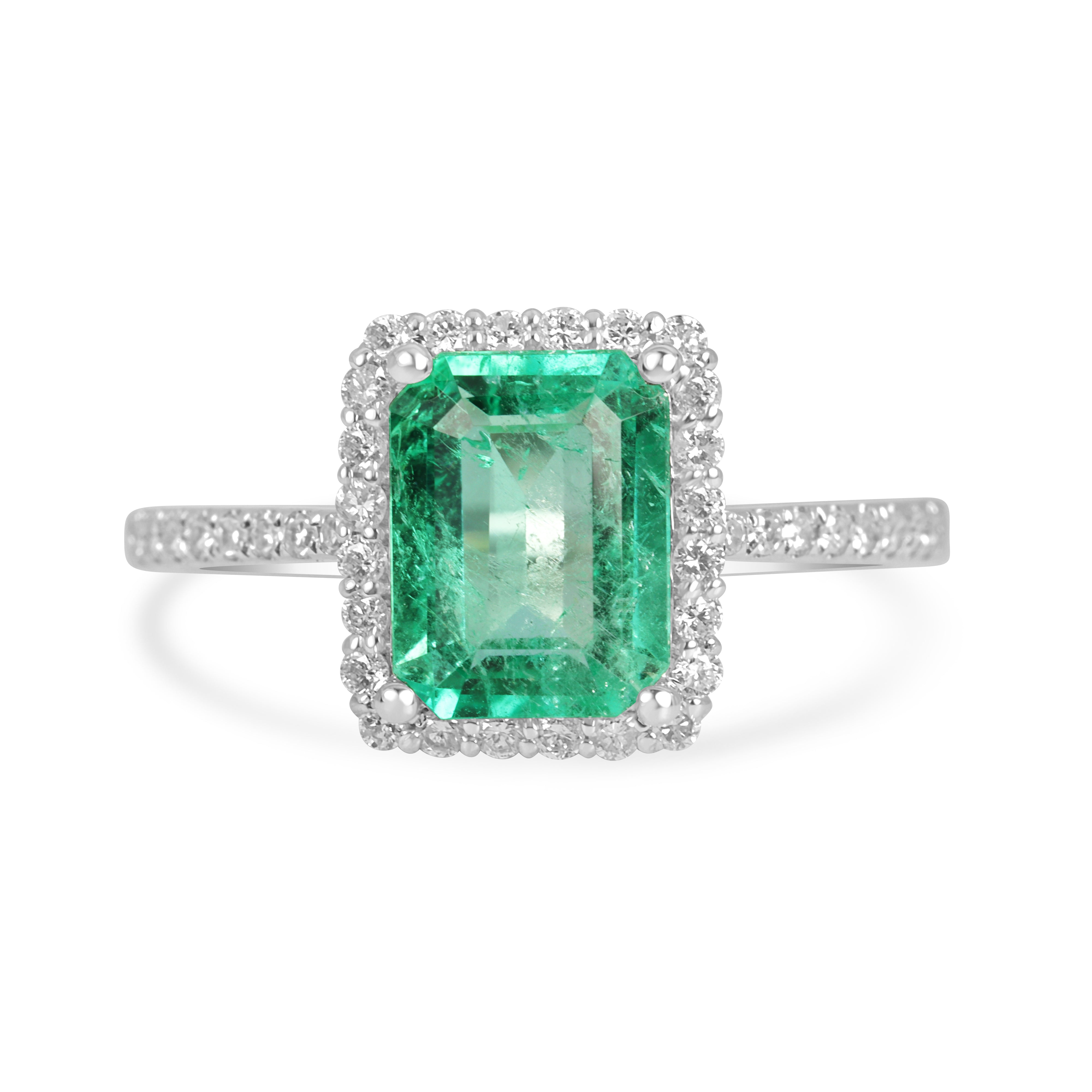 Elegant 14K white gold engagement ring with 1.70tcw Colombian emerald and diamond halo, featuring crystal-clear gemstones.