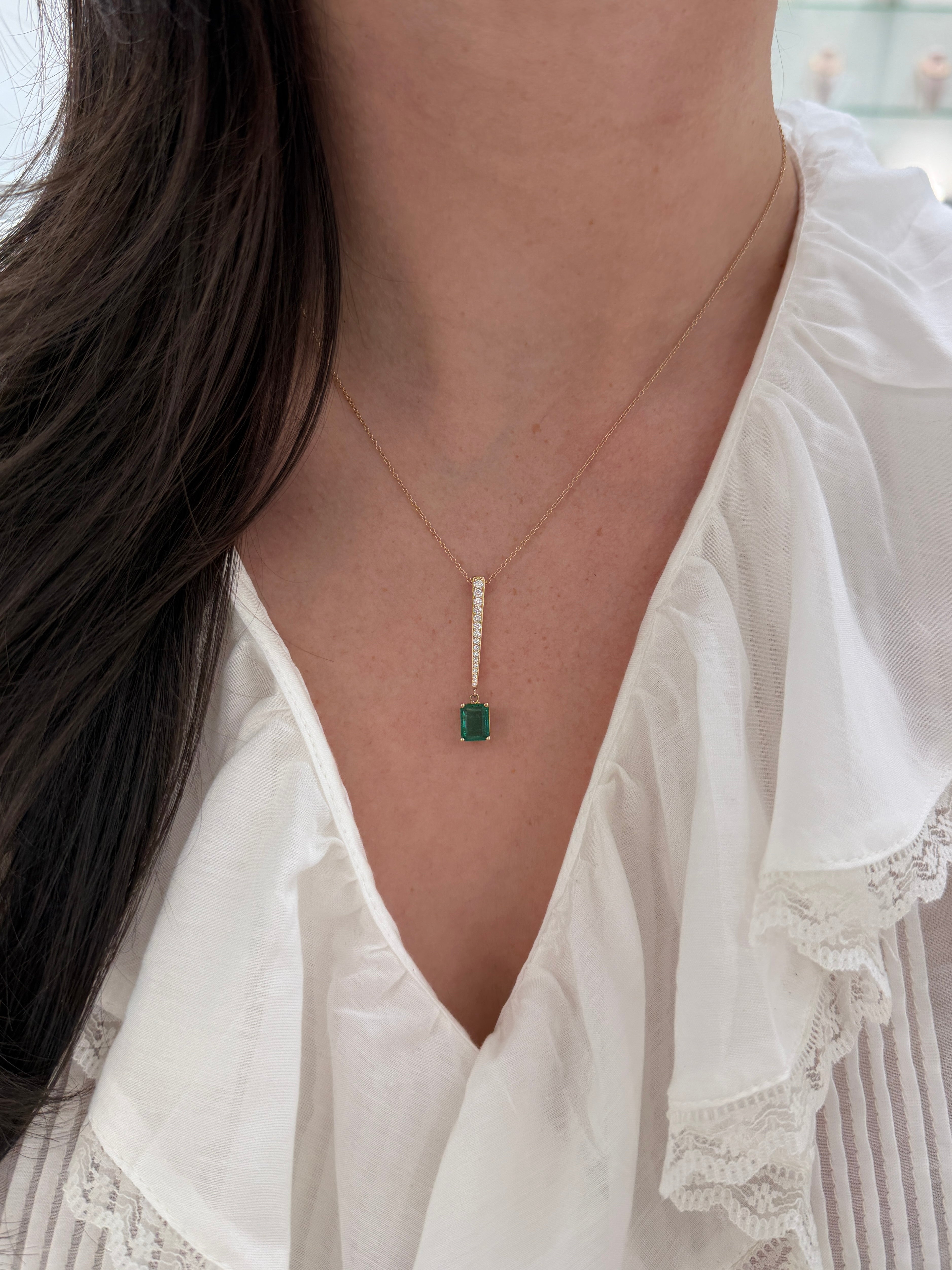 14K gold emerald and diamond V drop pendant necklace featuring a 2.68ctw emerald cut emerald and diamond accents by JR Colombian Emeralds
