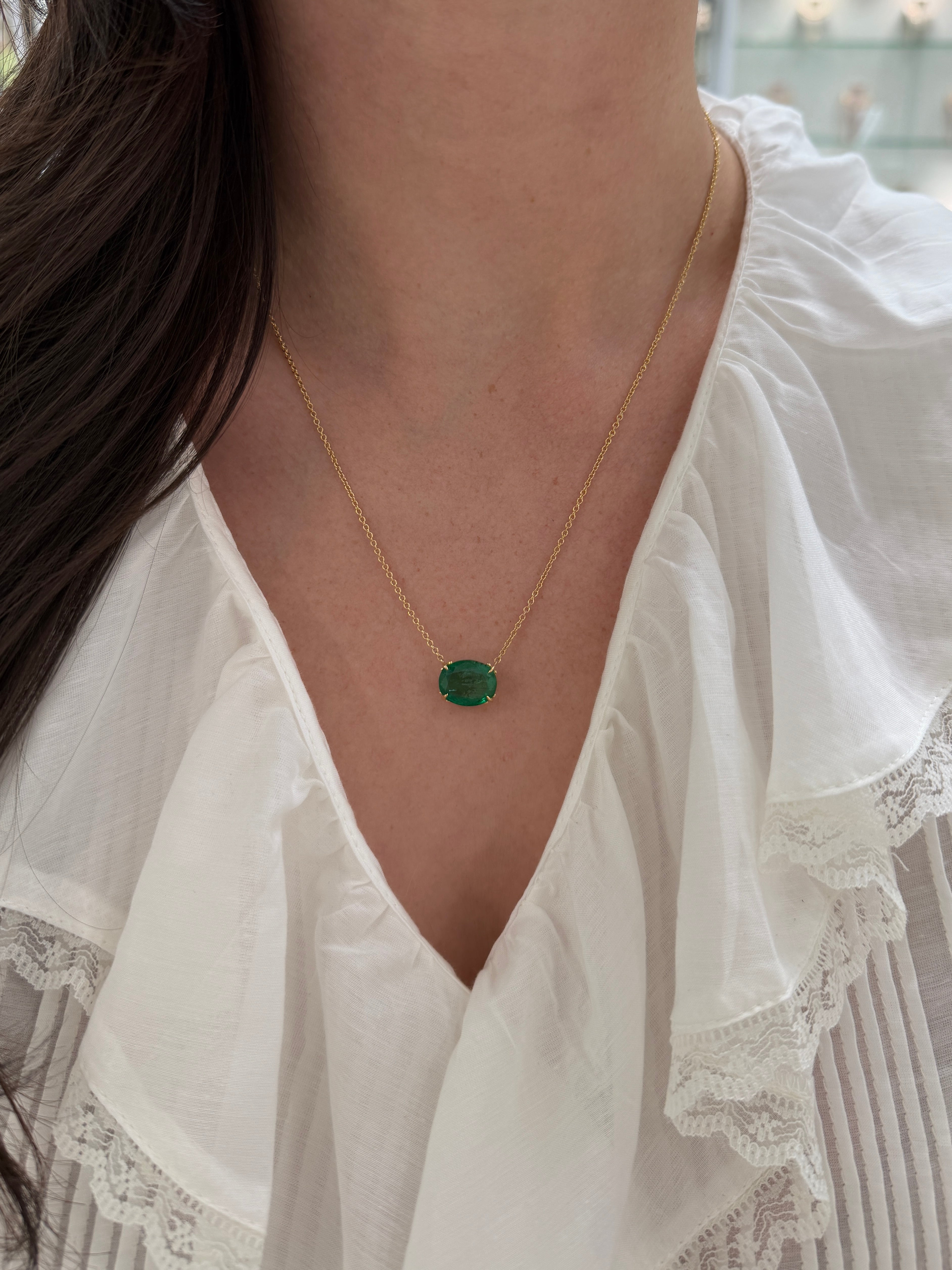 6.80ct 18K gold emerald necklace featuring an oval-shaped emerald and Fleur De Lis pendant by JR Colombian Emeralds.