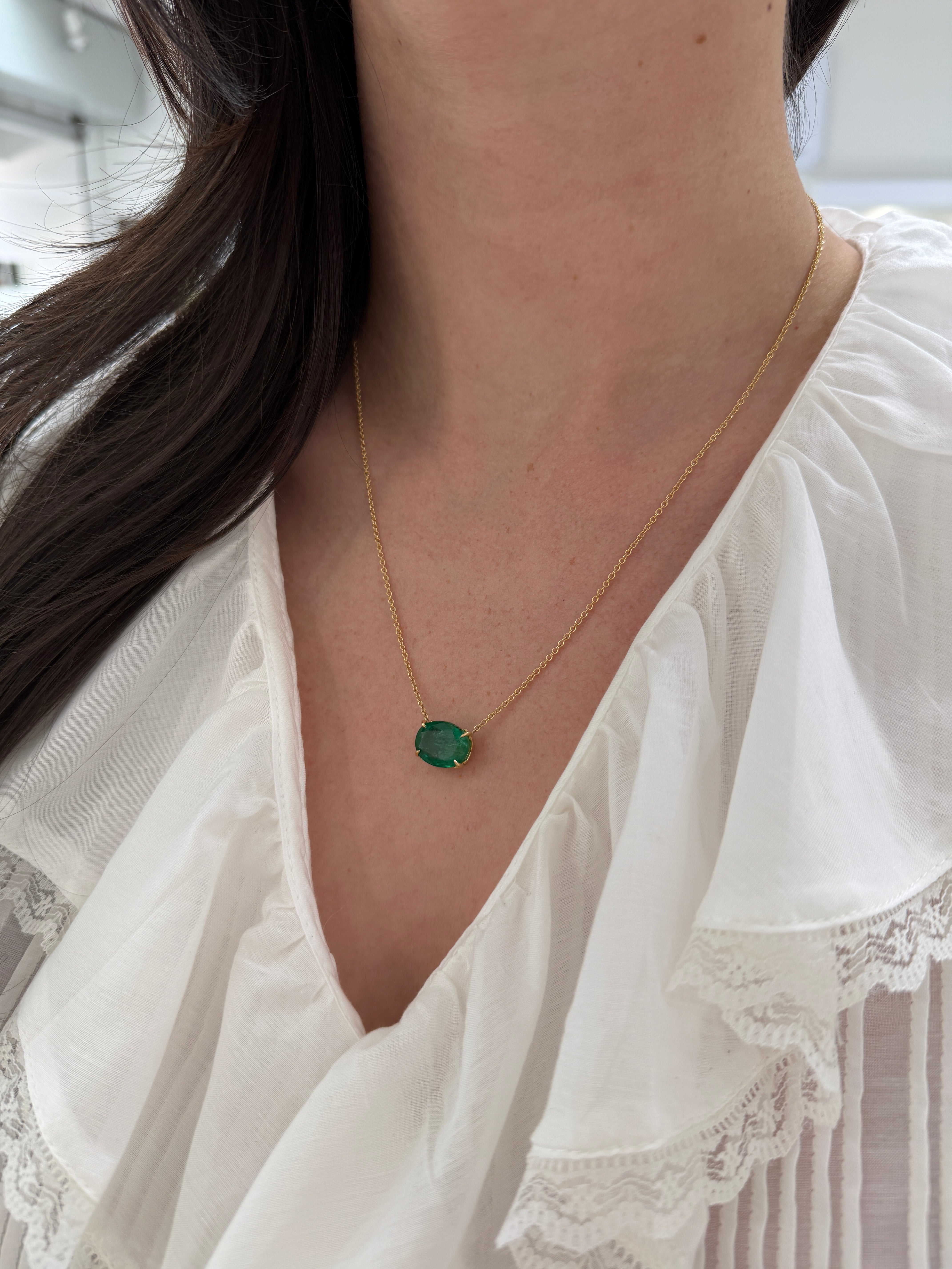18K gold emerald necklace featuring a 6.80ct oval Colombian emerald Fleur De Lis pendant, elegant jewelry from JR Colombian Emeralds
