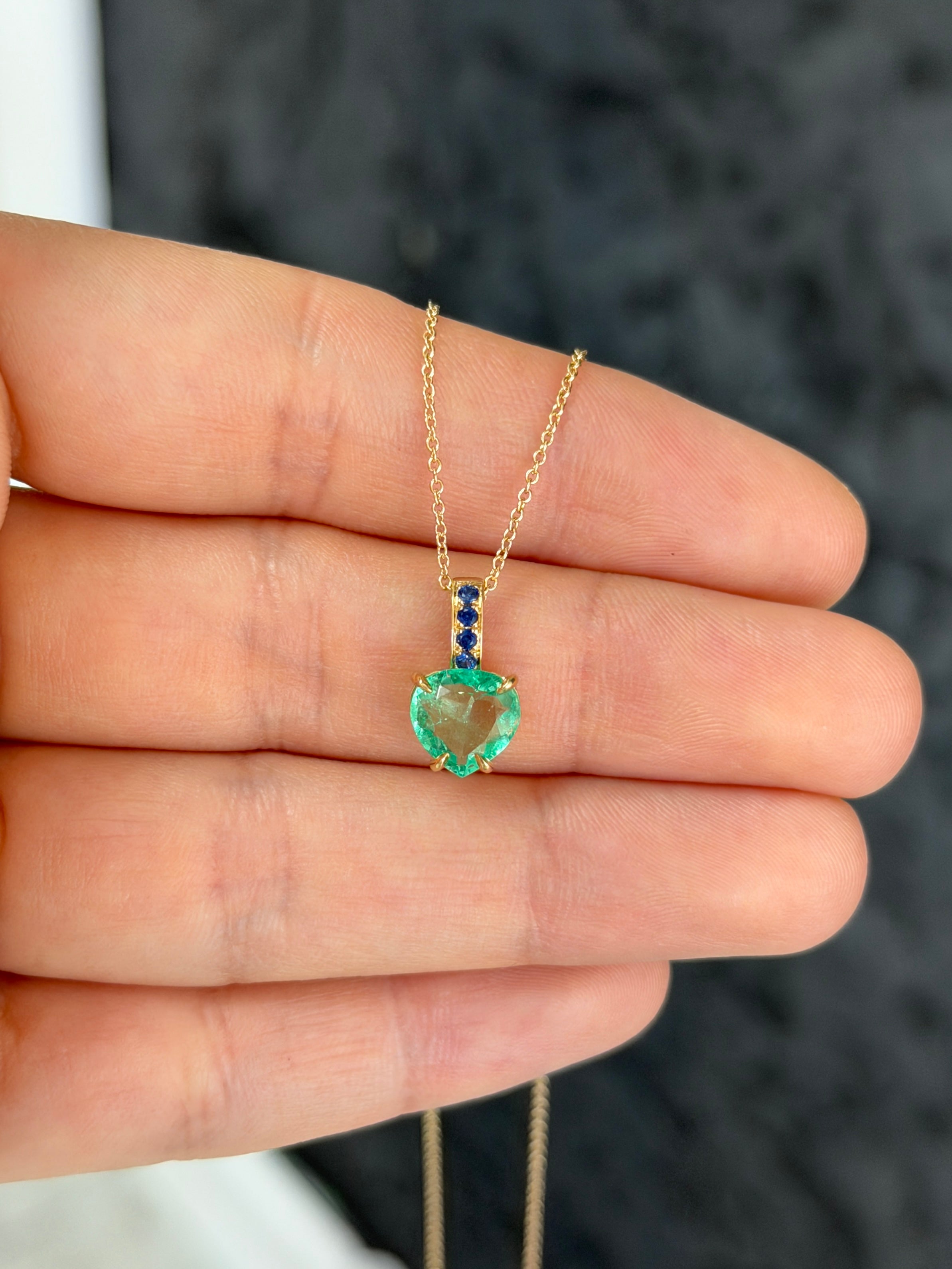 14K gold heart pendant with 1.09tcw Colombian pear emerald and blue sapphire bail, jewelry by JR Colombian Emeralds.