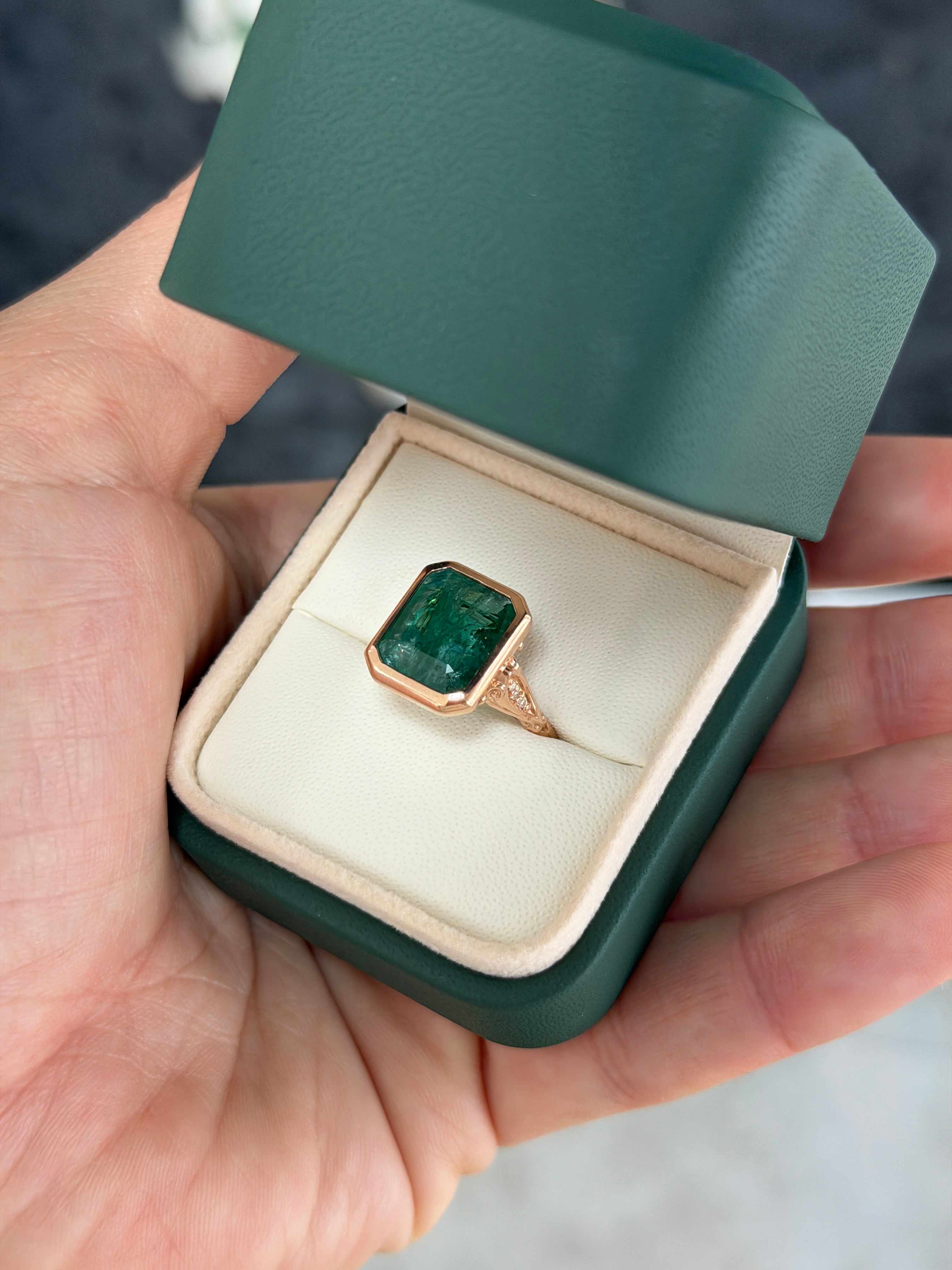 Vintage-inspired emerald bezel ring with diamond shank and scroll basket detail in 14K rose gold by JR Colombian Emeralds.