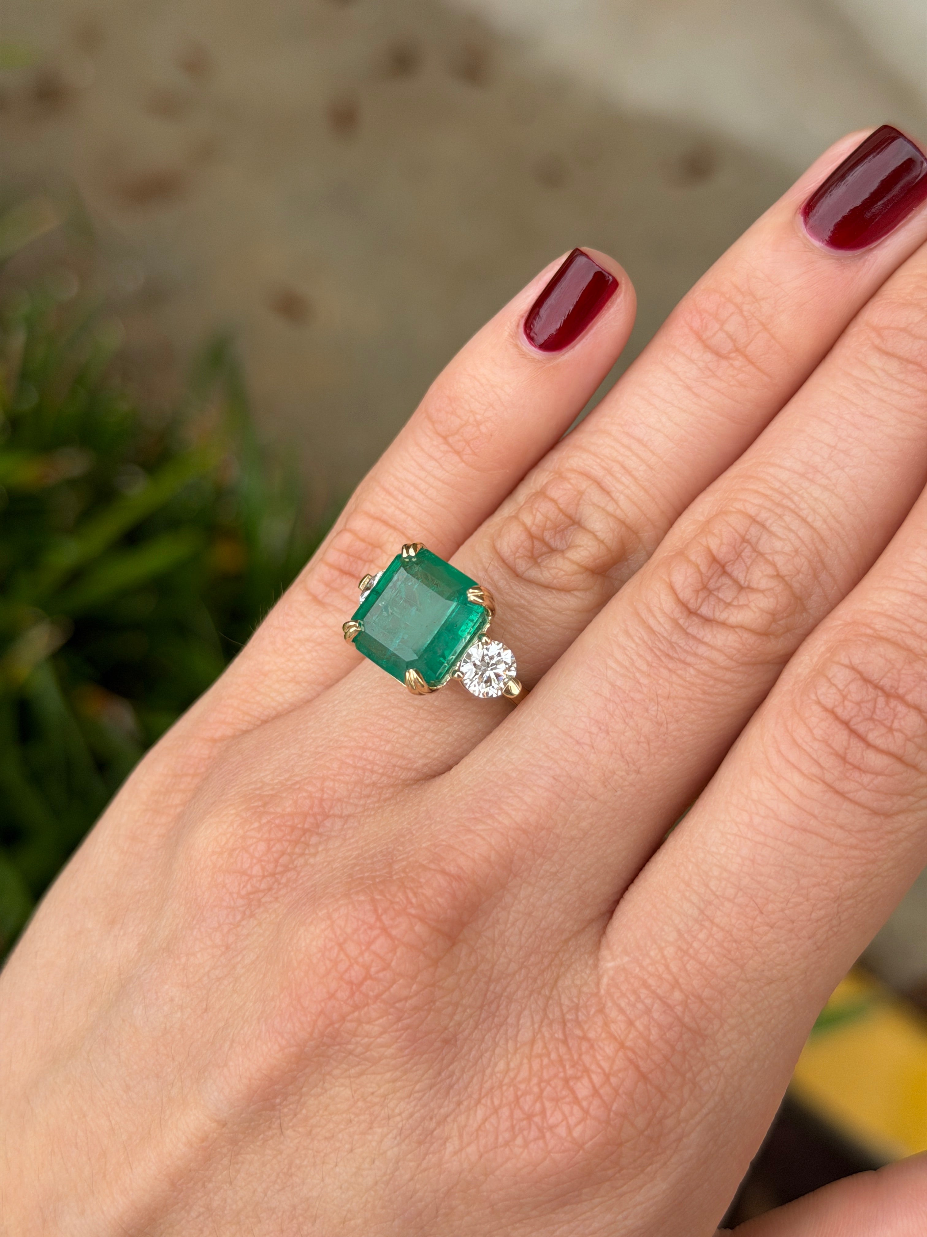 Three-stone Asscher cut emerald engagement ring with round lab diamonds in 14K gold cathedral setting by JR Colombian Emeralds.
