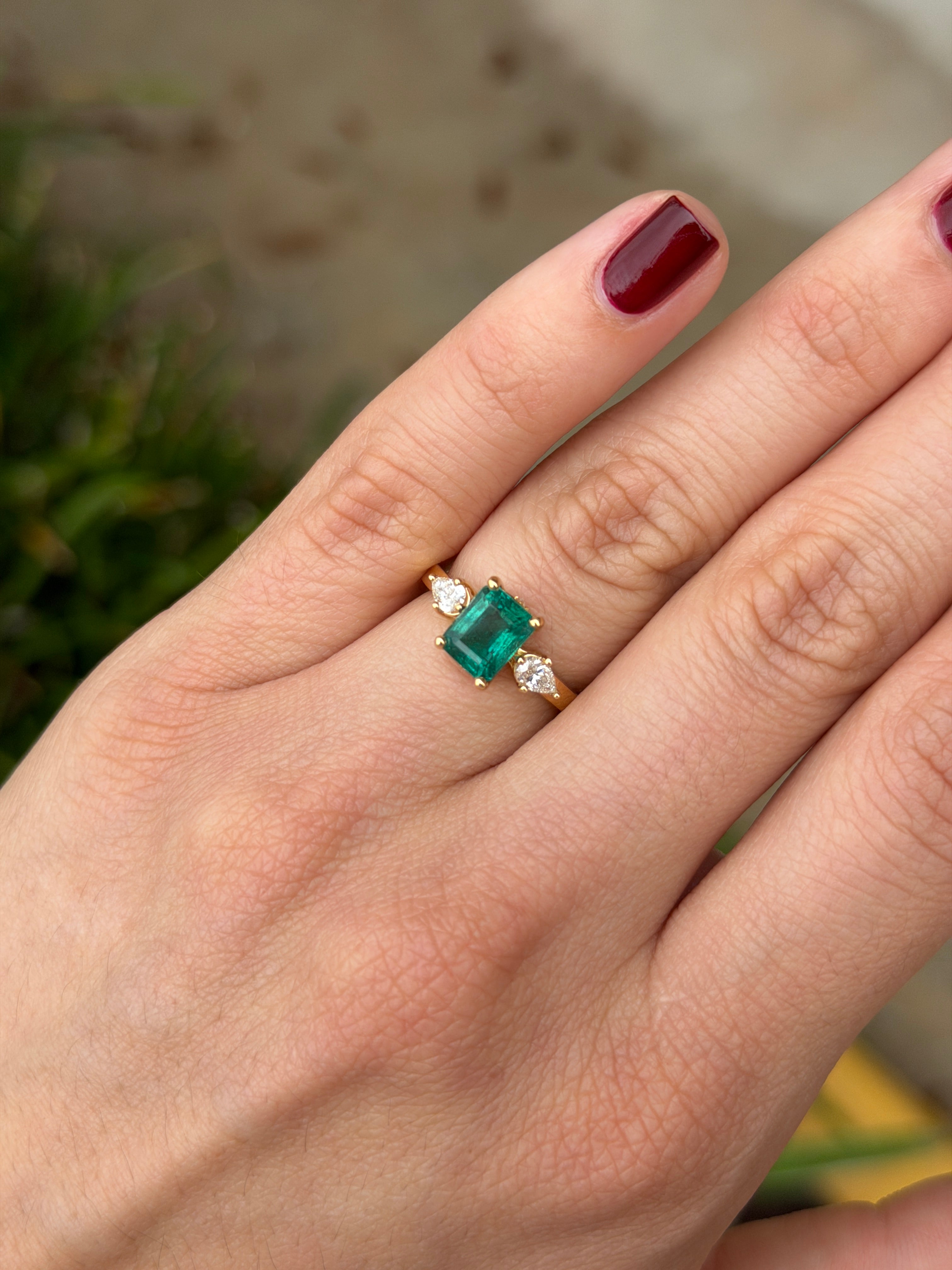Emerald cut and pear-shaped diamond three-stone ring with hidden diamond accents in 18K gold by JR Colombian Emeralds.