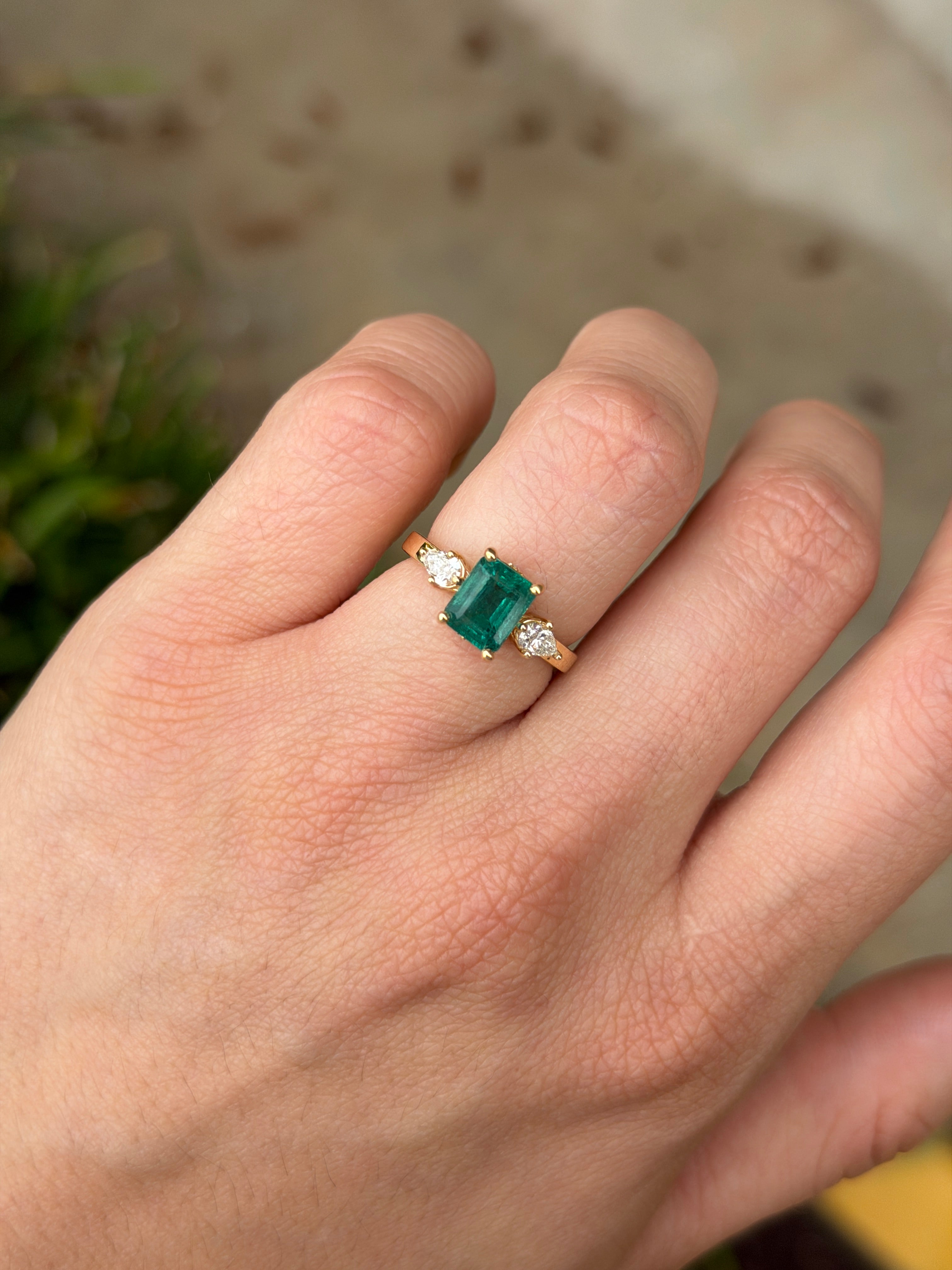 Emerald cut and pear shape emerald and diamond three-stone ring with hidden accent diamonds in 18K gold by JR Colombian Emeralds