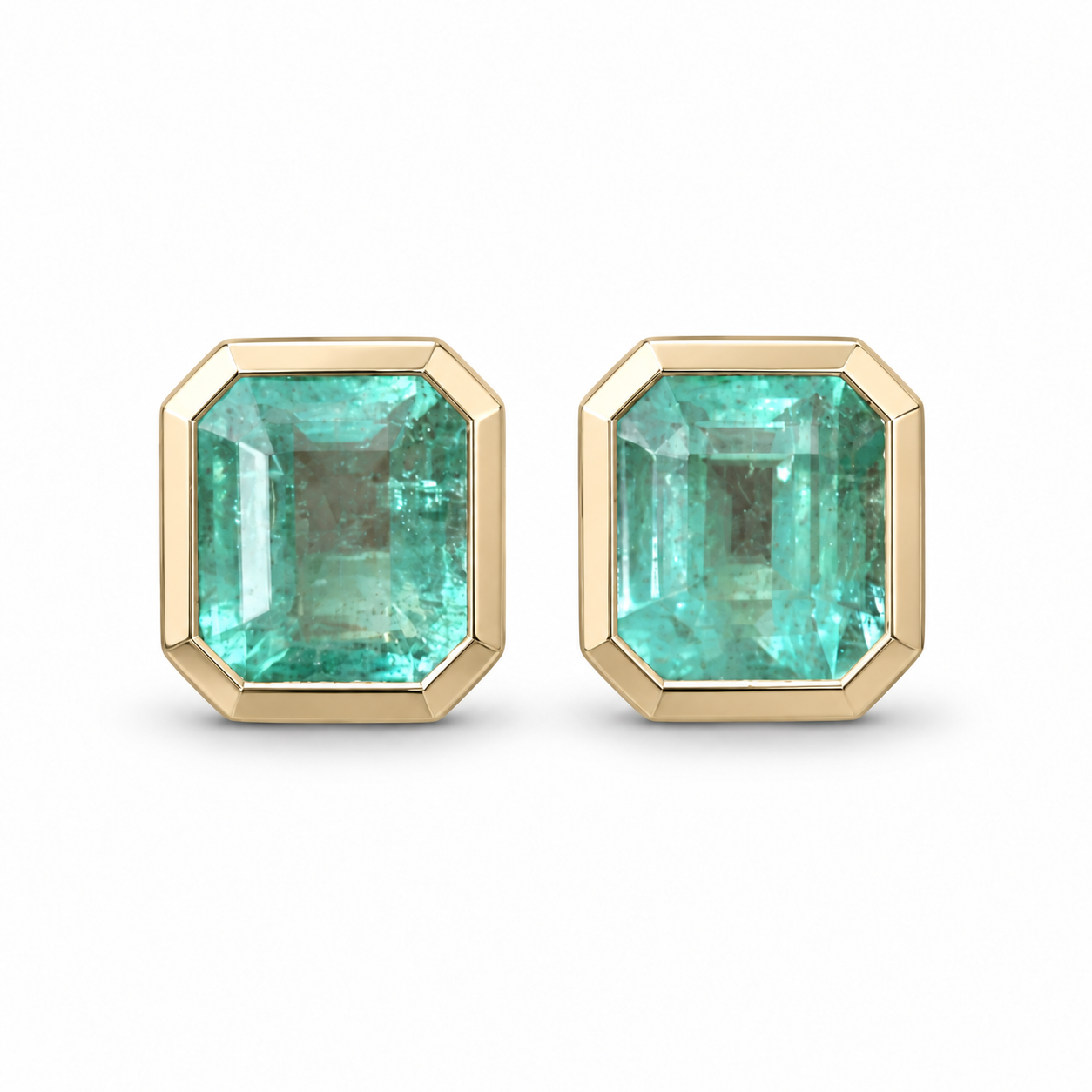 Polished champagne gold stud earrings featuring 6.80tcw natural Colombian emeralds in a bezel setting, by JR Colombian Emeralds.