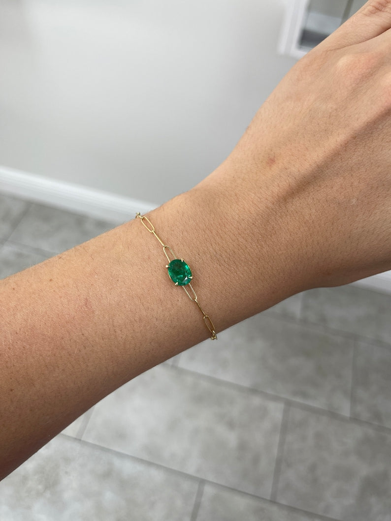 Colombian Emerald bracelet with 2.10ct oval cut emerald in 14K gold setting, featuring a paperclip design with four prongs.