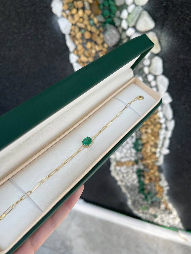 14K Colombian emerald bracelet with 2.10ct oval cut green emerald, paperclip style, 4-prong setting, medium dark green color.